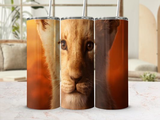 Close-up of a young lion's face on three tumblers.
