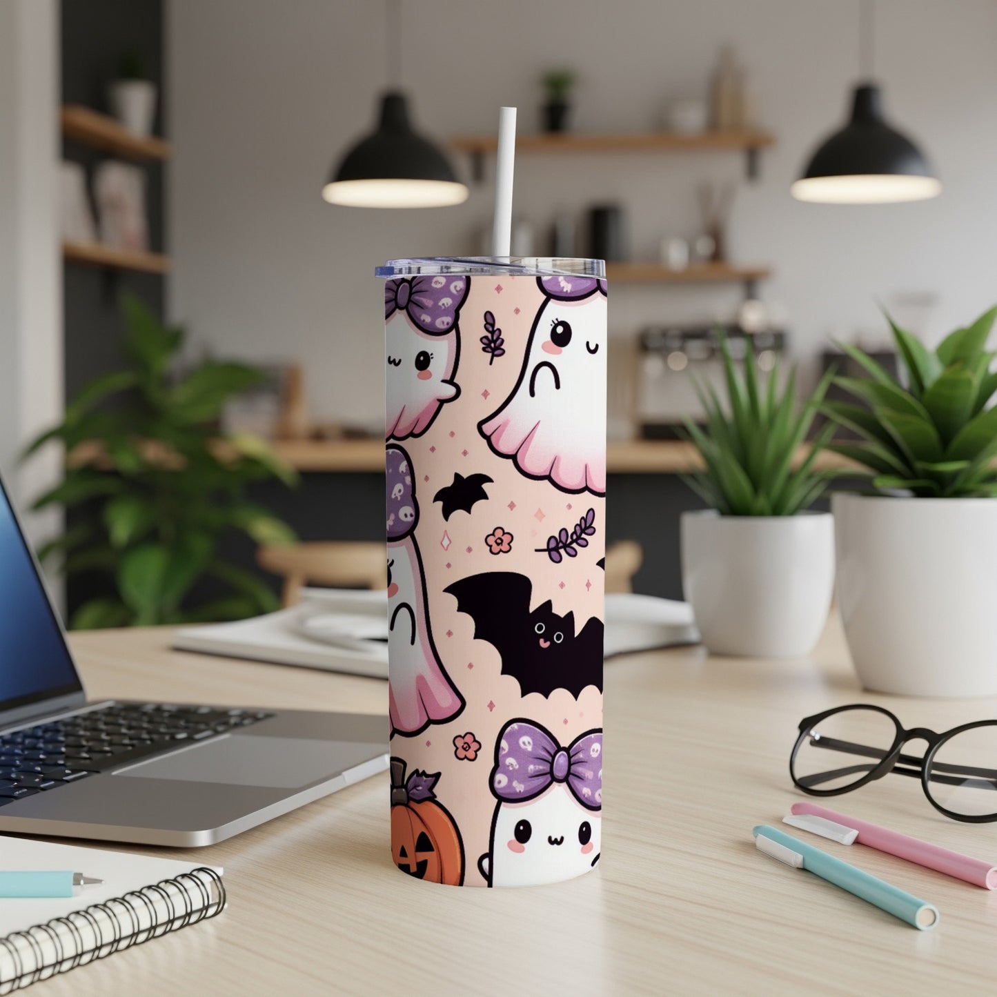 Pink tumbler with cute ghosts, bats, pumpkin, and bows, featuring a straw.
