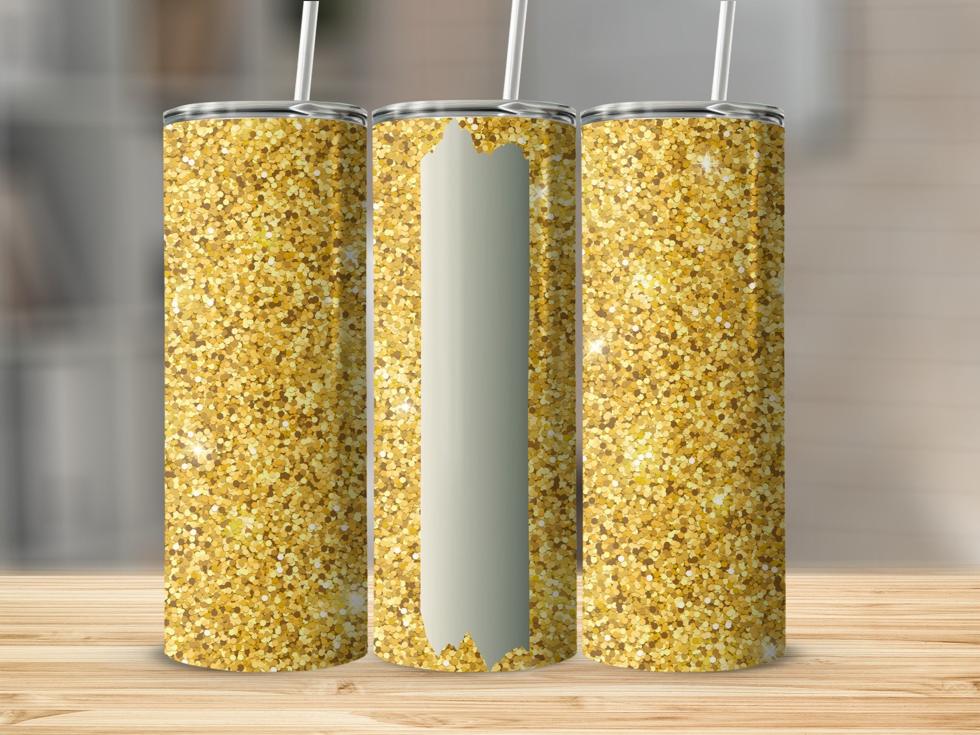 Three gold glitter tumblers with straws on a wooden surface.