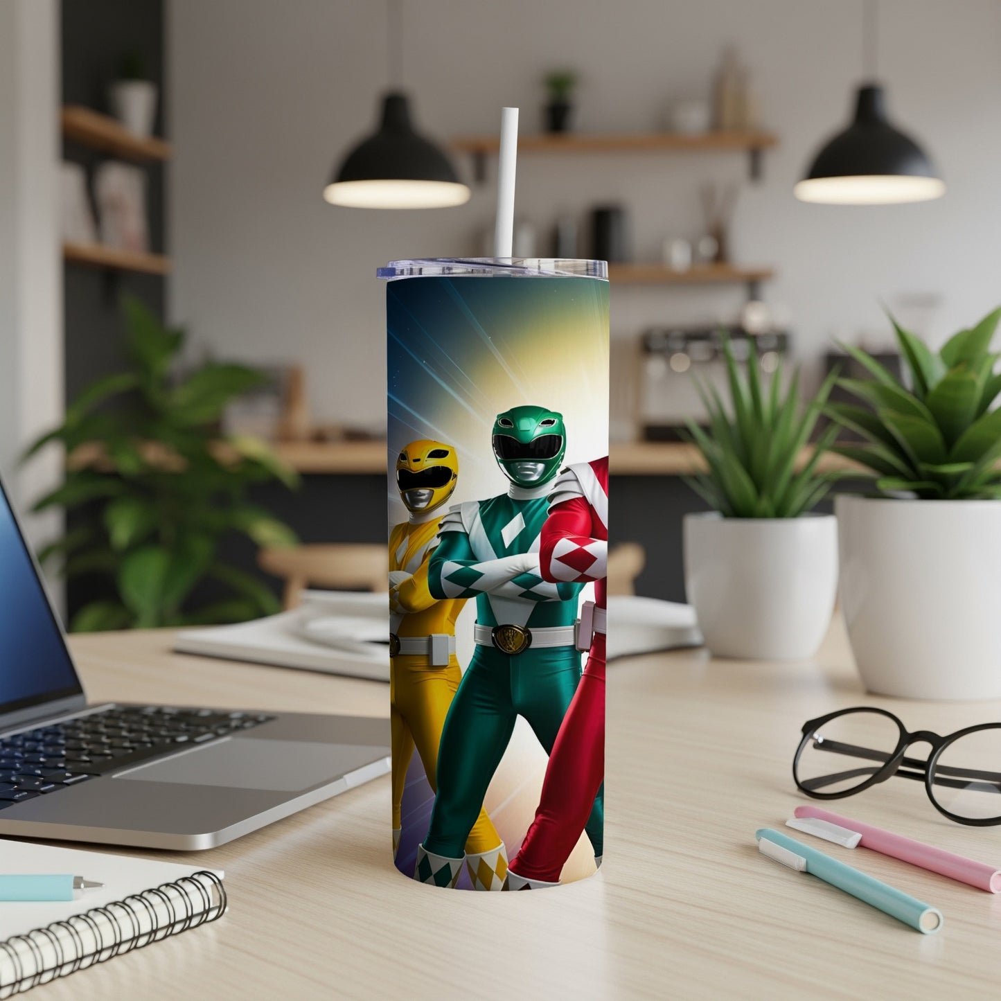 Three Power Rangers in colorful suits stand facing forward on a tumbler.