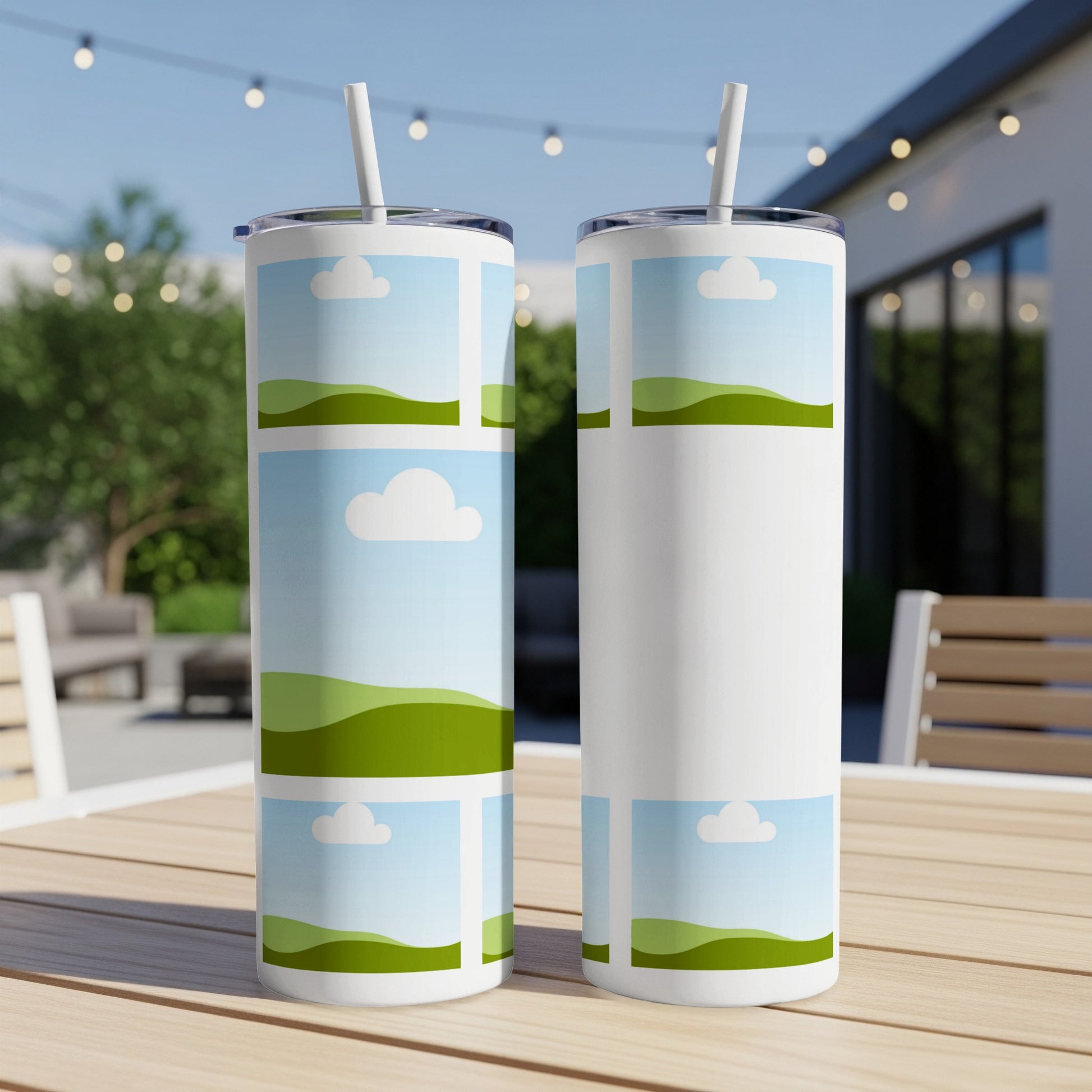 Two tumblers with a cartoon sky and green hill design.