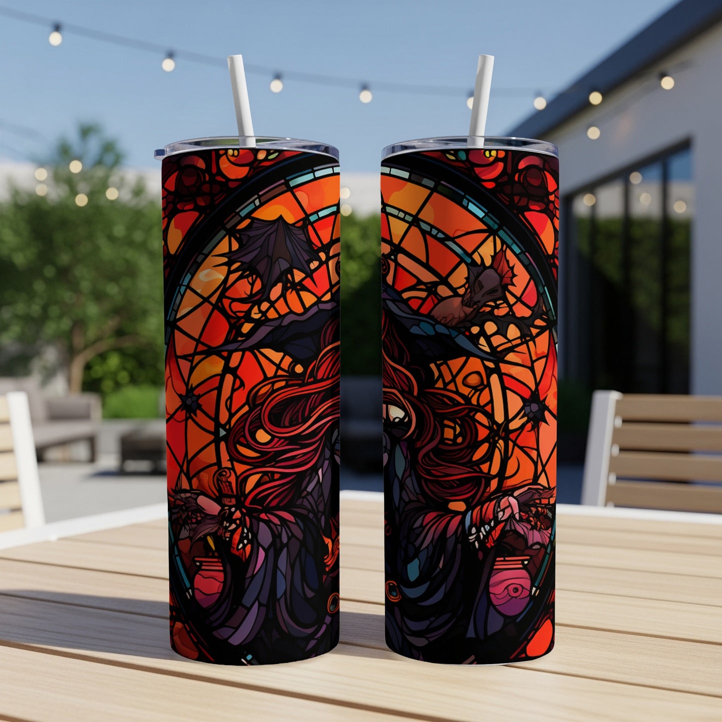 Two tumblers with witch and stained glass design, outdoors.