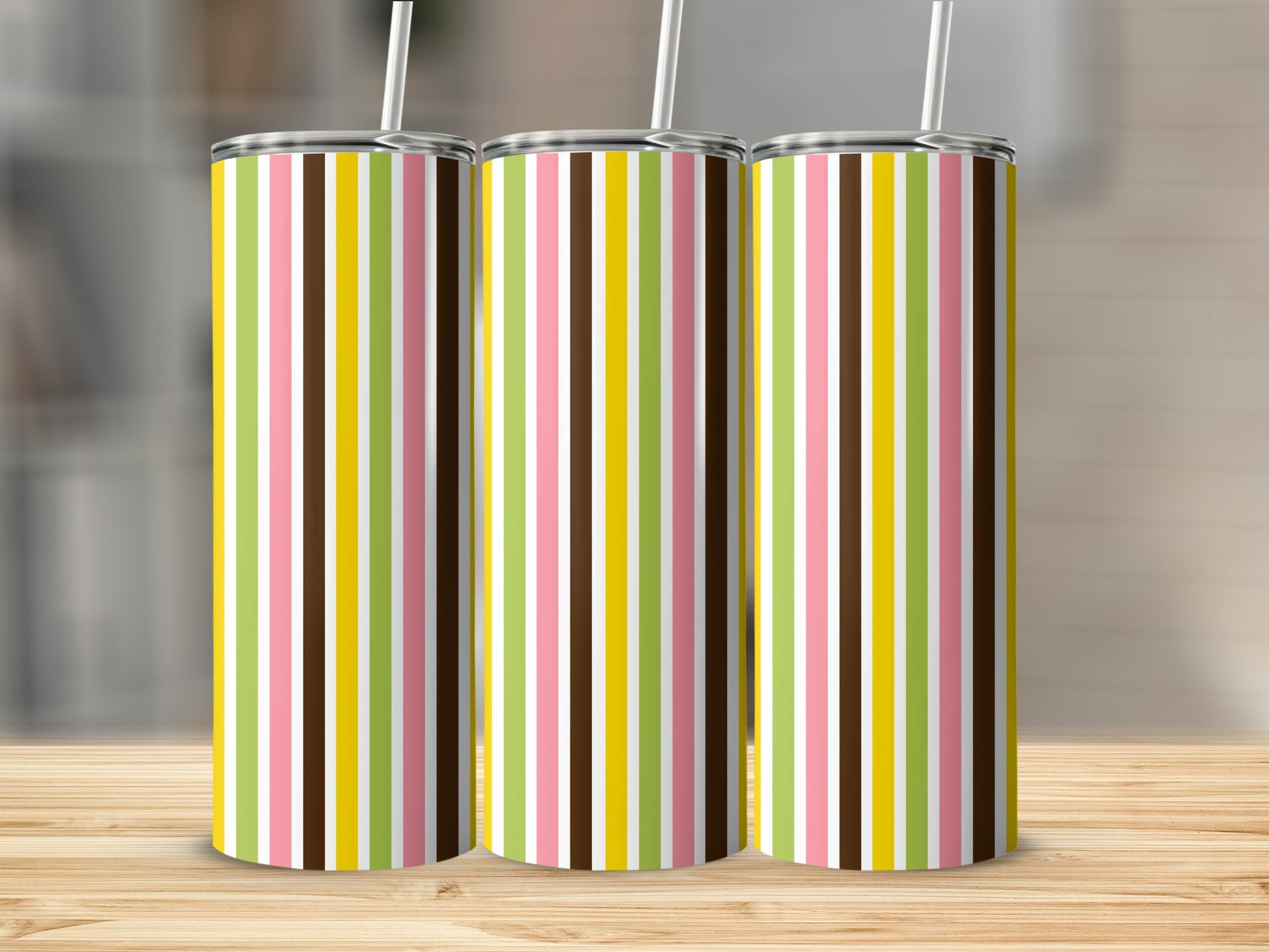 Three tumblers with vertical stripes in pink, white, brown, yellow, and green.