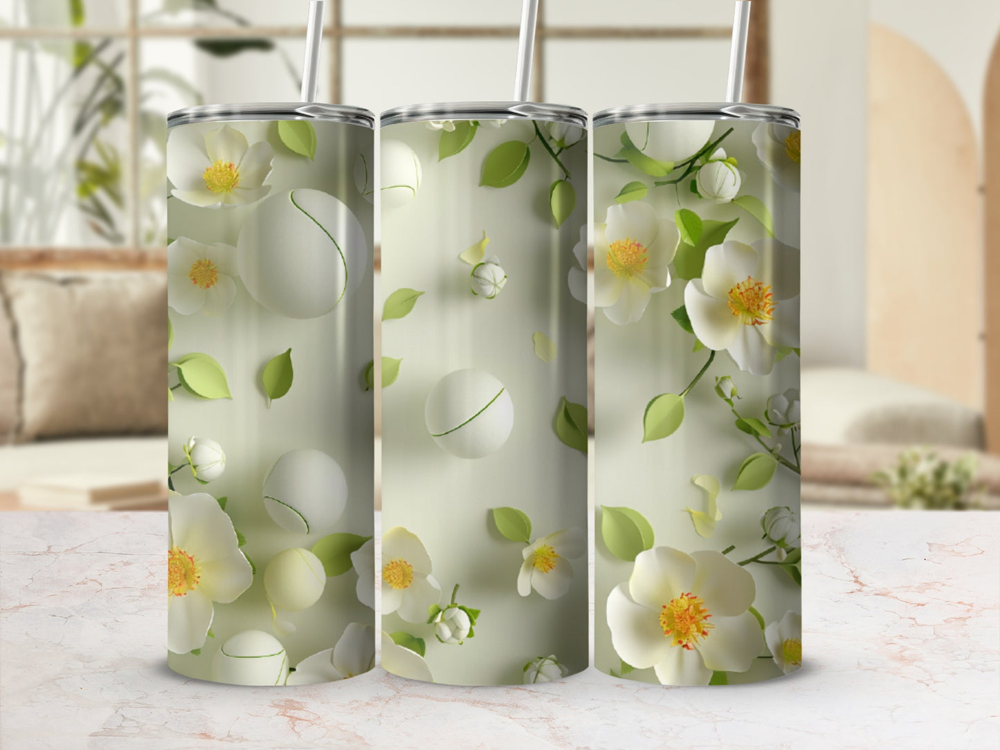 Three white floral tumblers with green leaves on a light background.