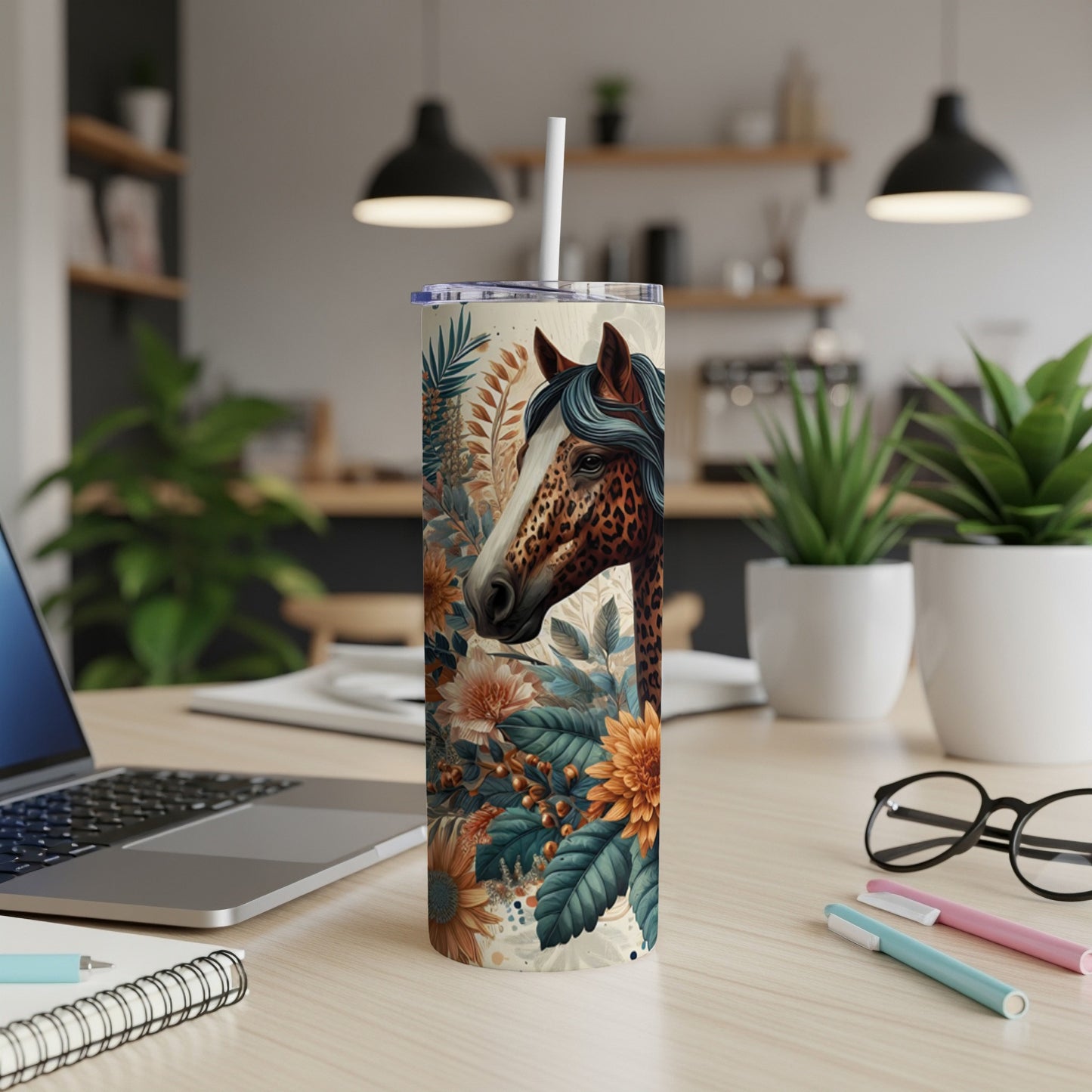 Horse head with floral pattern on a skinny tumbler with laptop and pens.