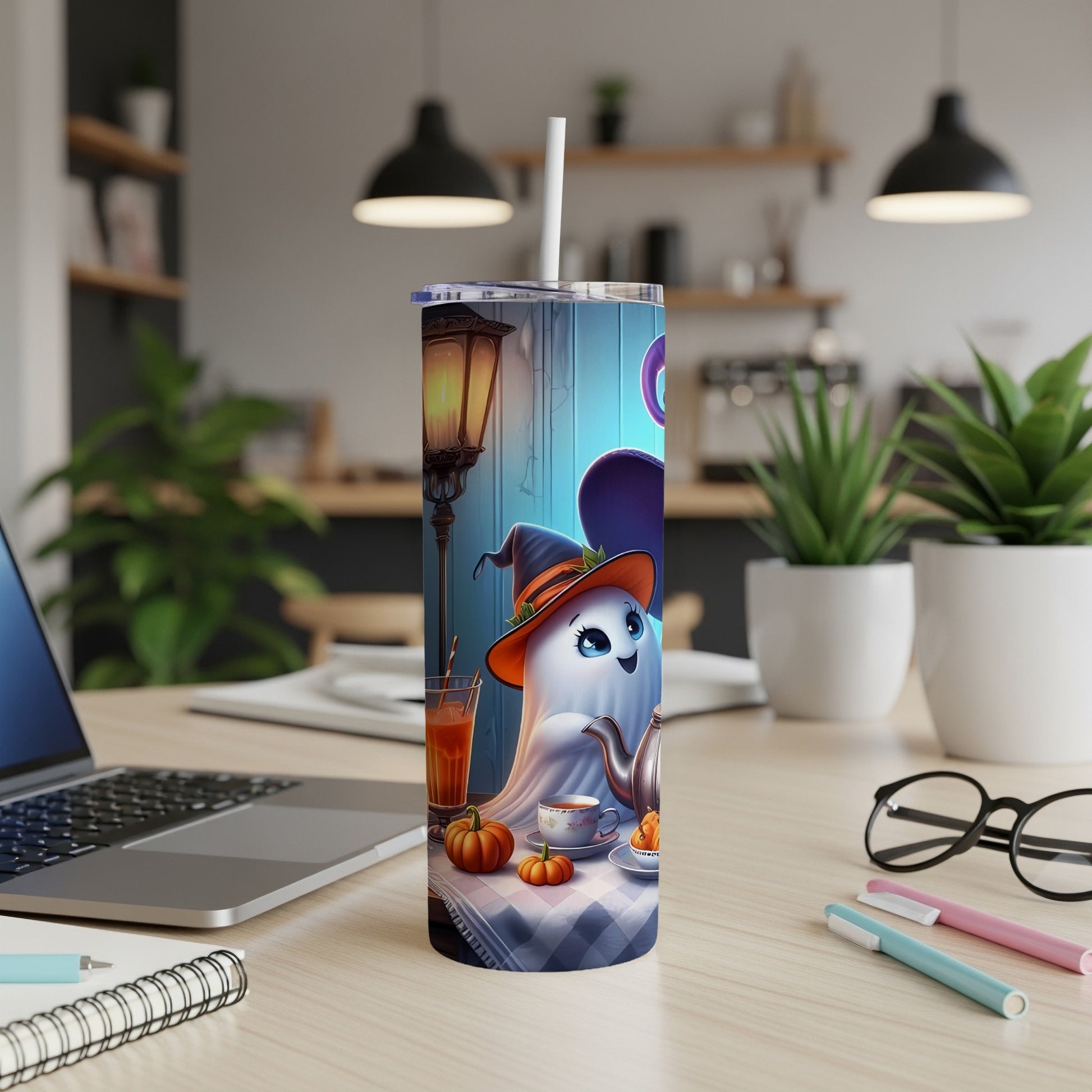 Tumbler with cartoon ghost in witch hat, tea set, and pumpkins.