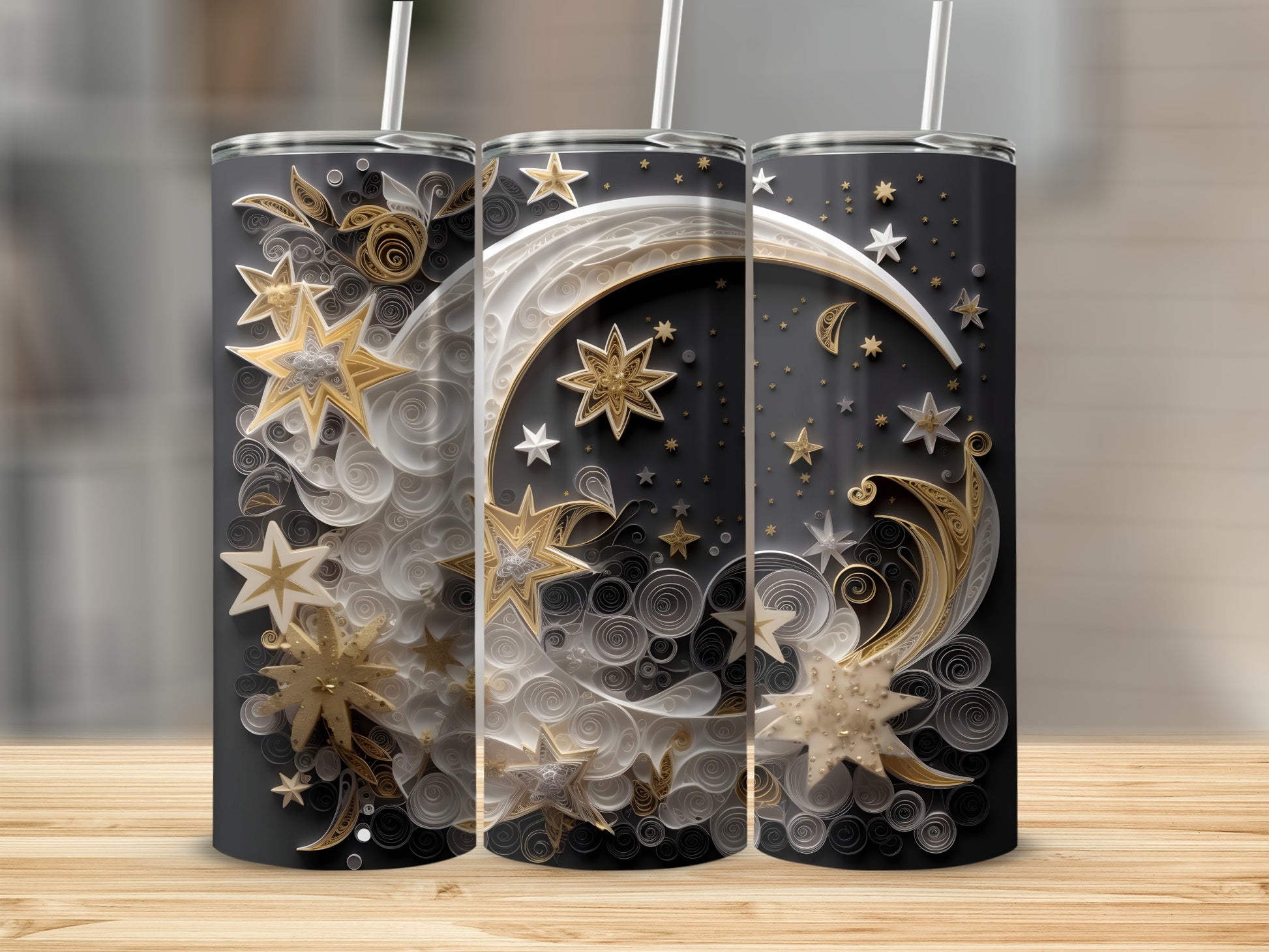 Three black tumblers with celestial moon and star designs.