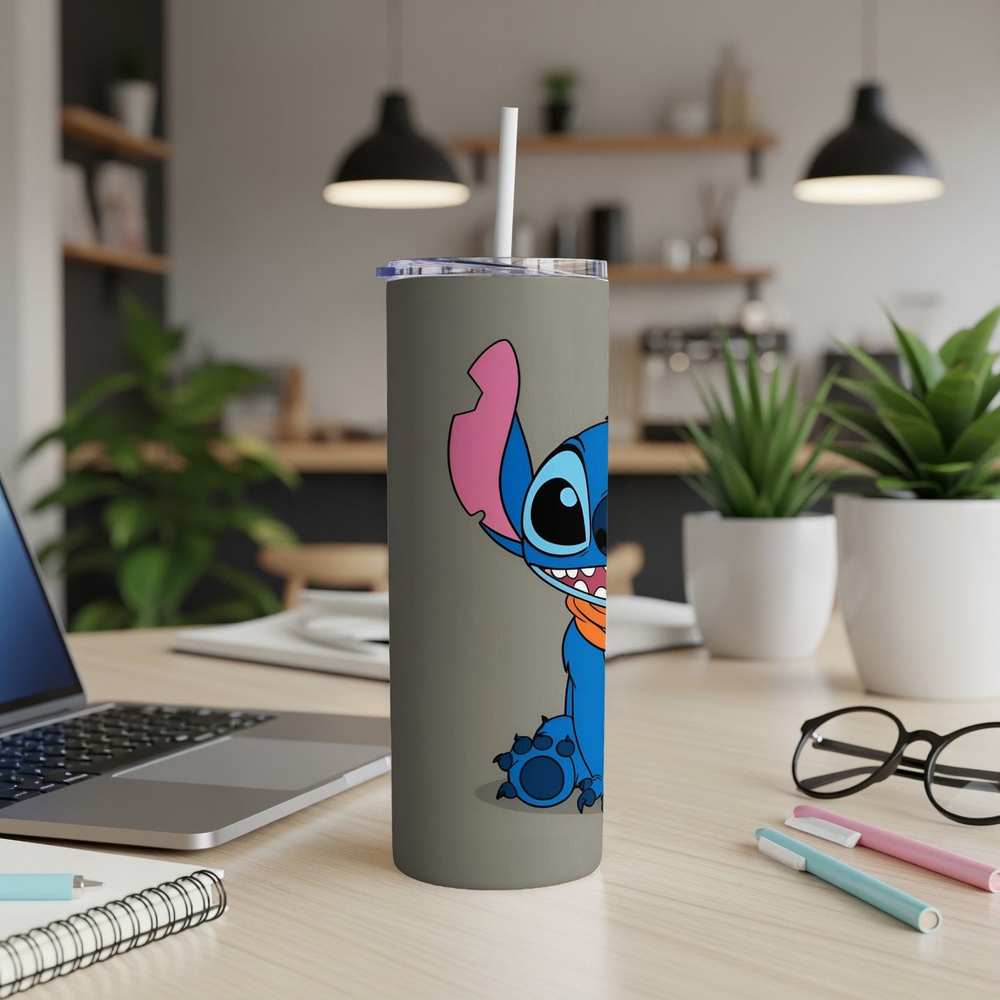 Blue Stitch character on a gray tumbler with a white straw.