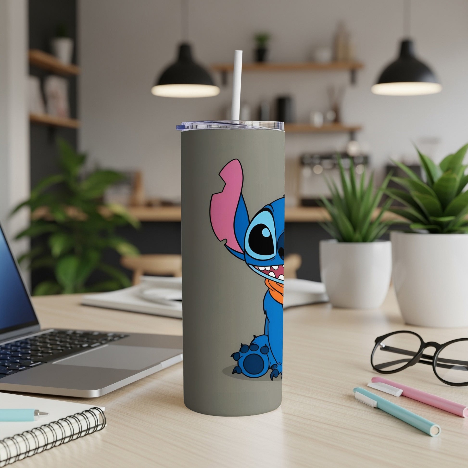 Blue Stitch character on a gray tumbler with a white straw.