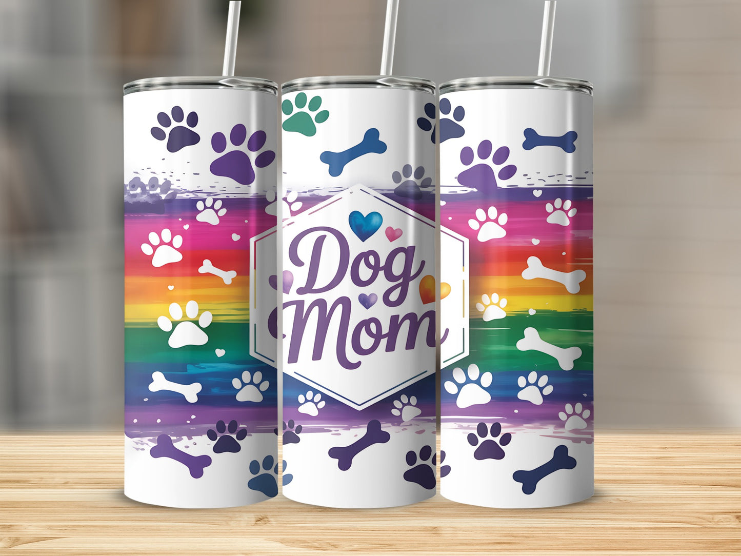 Dog Mom tumbler with rainbow paw prints and bone graphic.