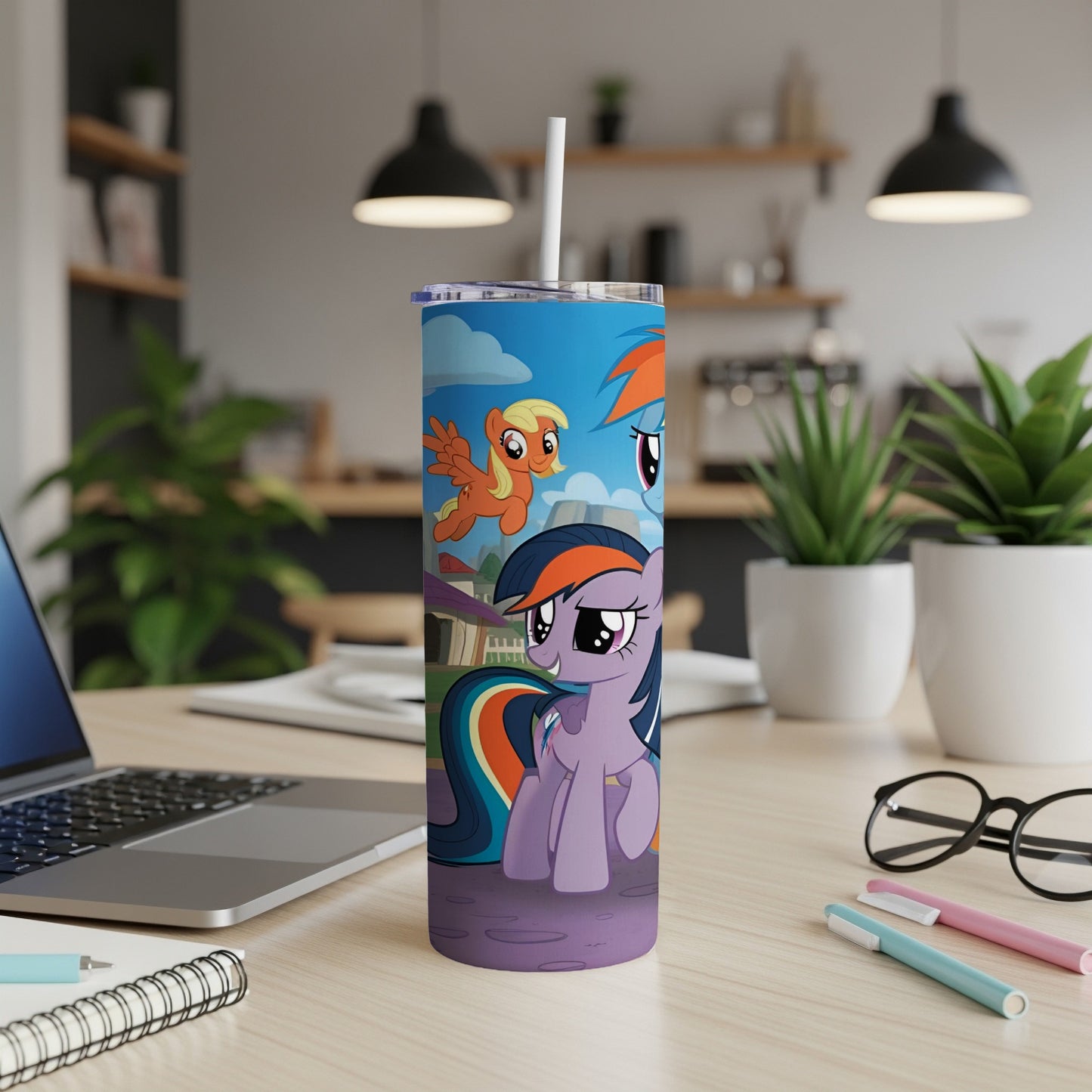 My Little Pony characters on a blue tumbler with a white straw.