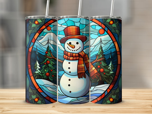 Stained glass snowman with scarf and hat, surrounded by snowy trees and mountains.