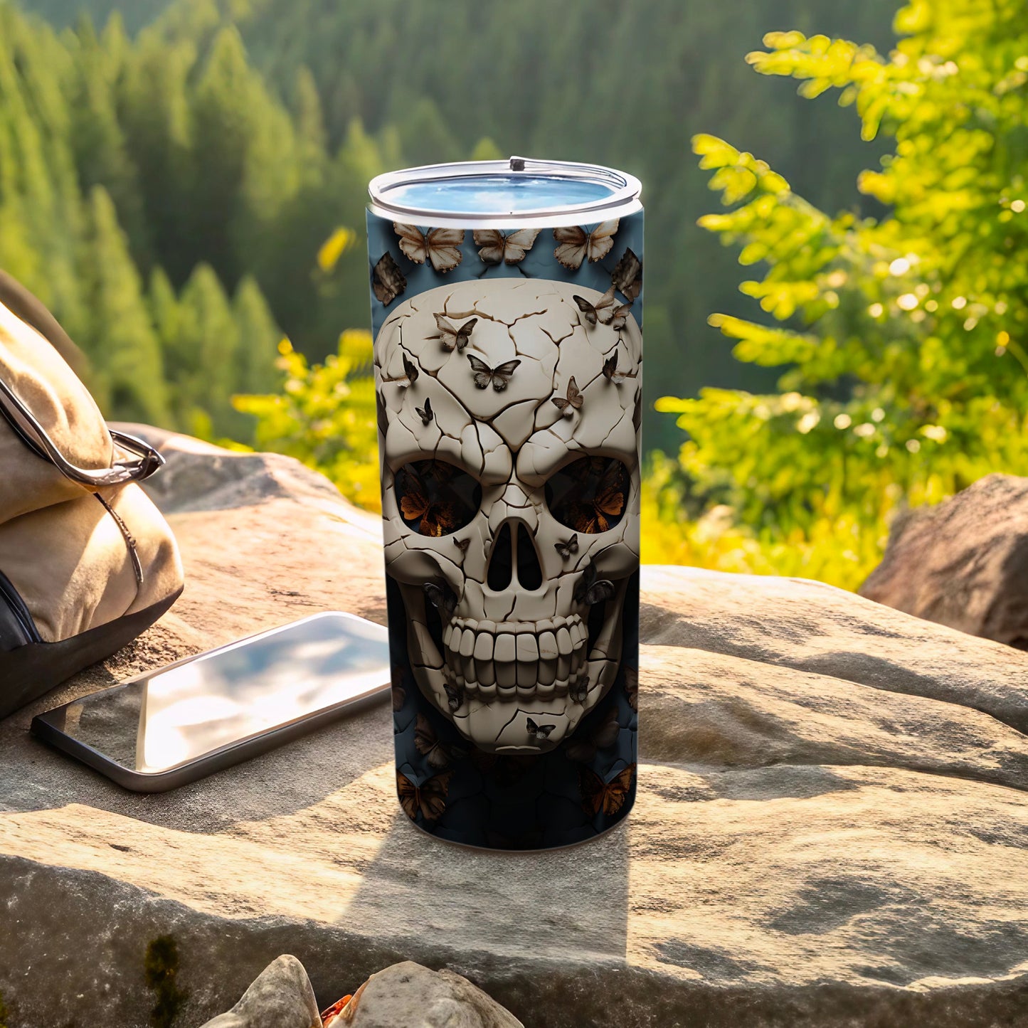 Tumbler with a cracked skull design and butterflies.