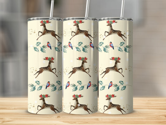 Three tumblers with a Christmas deer and bird pattern on a wooden surface.