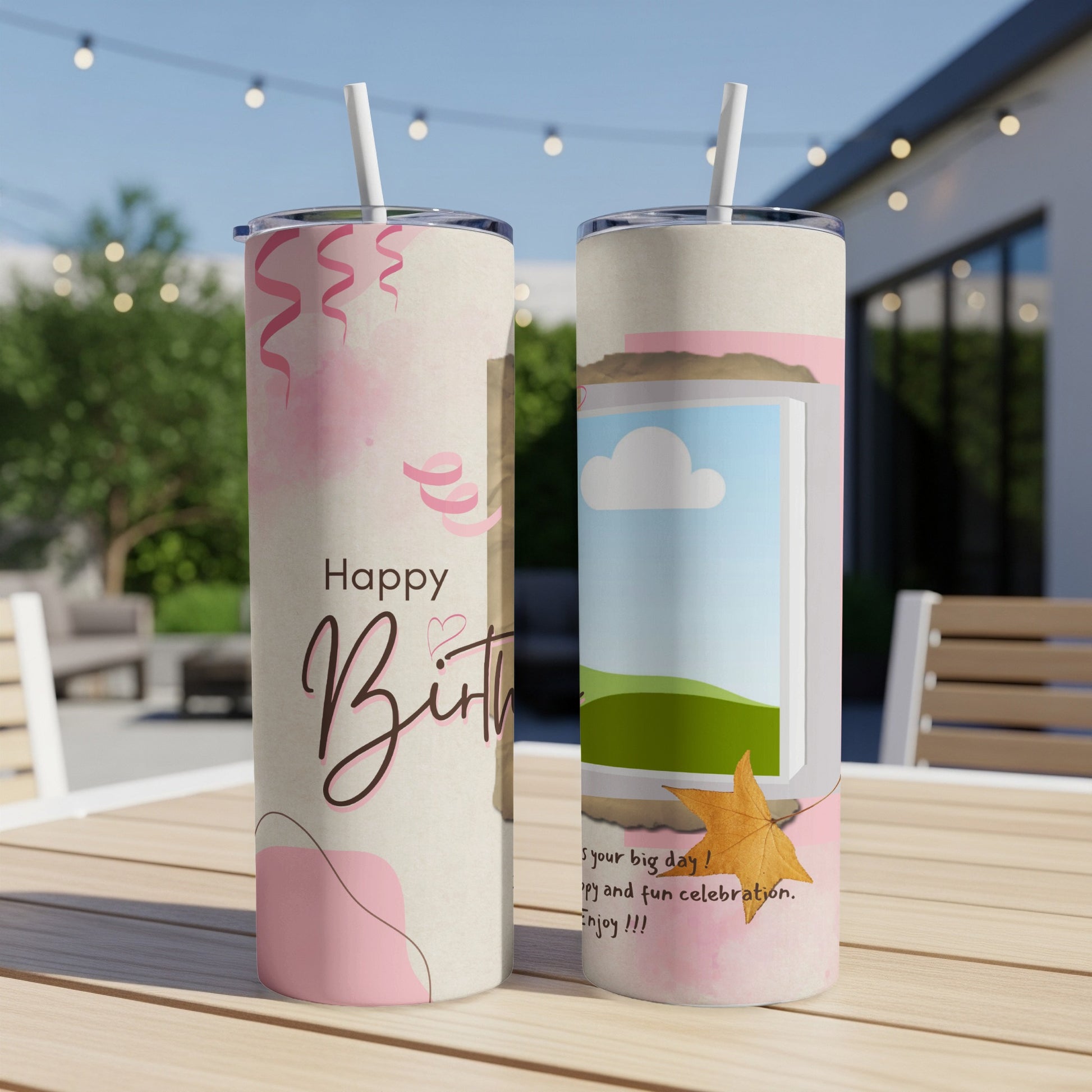 Two tumblers with birthday designs on a wooden table.