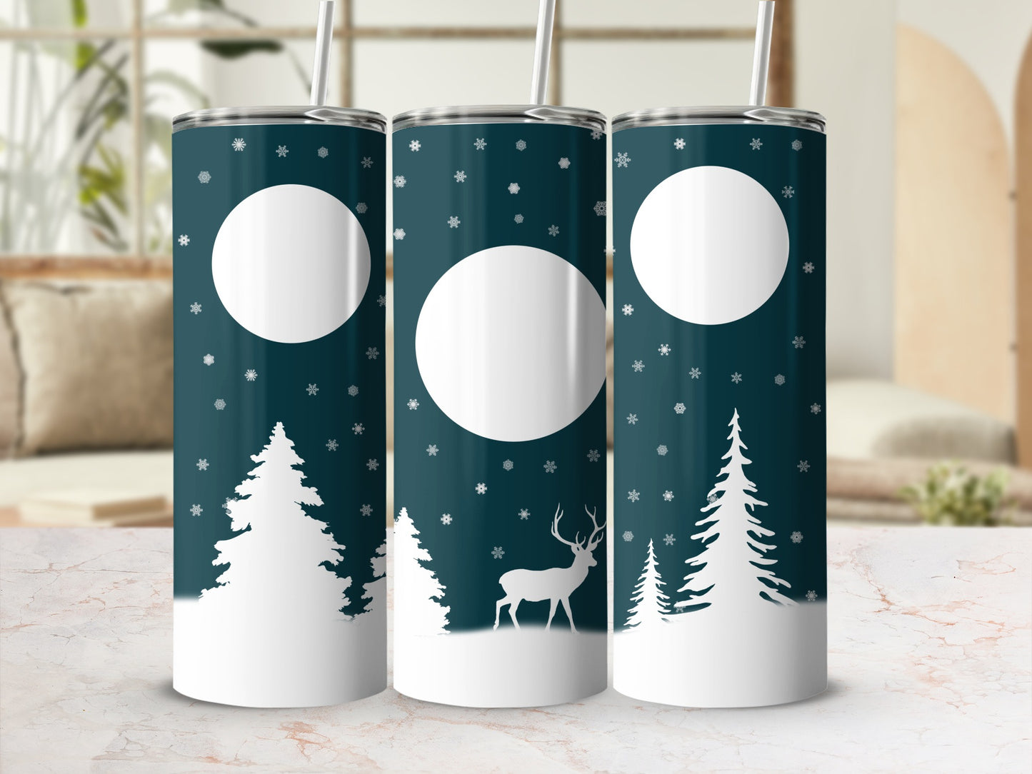 Dark teal tumbler with white snowflakes, trees, and a deer silhouette.