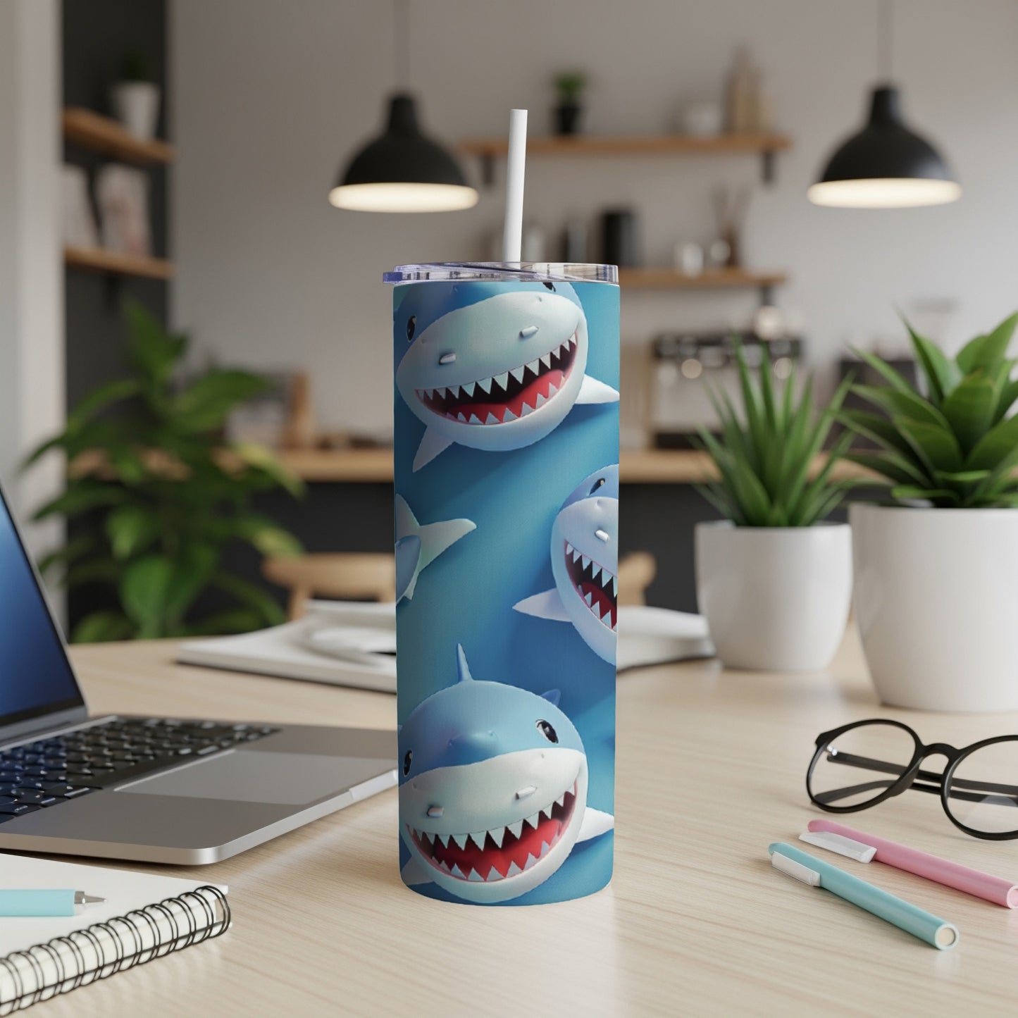 Cute cartoon sharks on a blue background cover a white insulated tumbler with a straw.