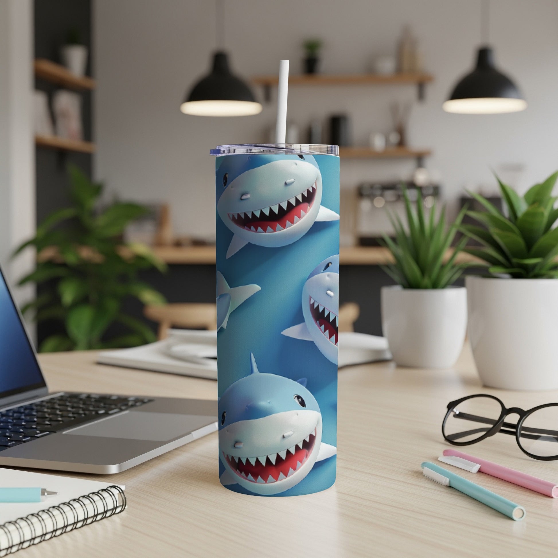 Cute cartoon sharks on a blue background cover a white insulated tumbler with a straw.