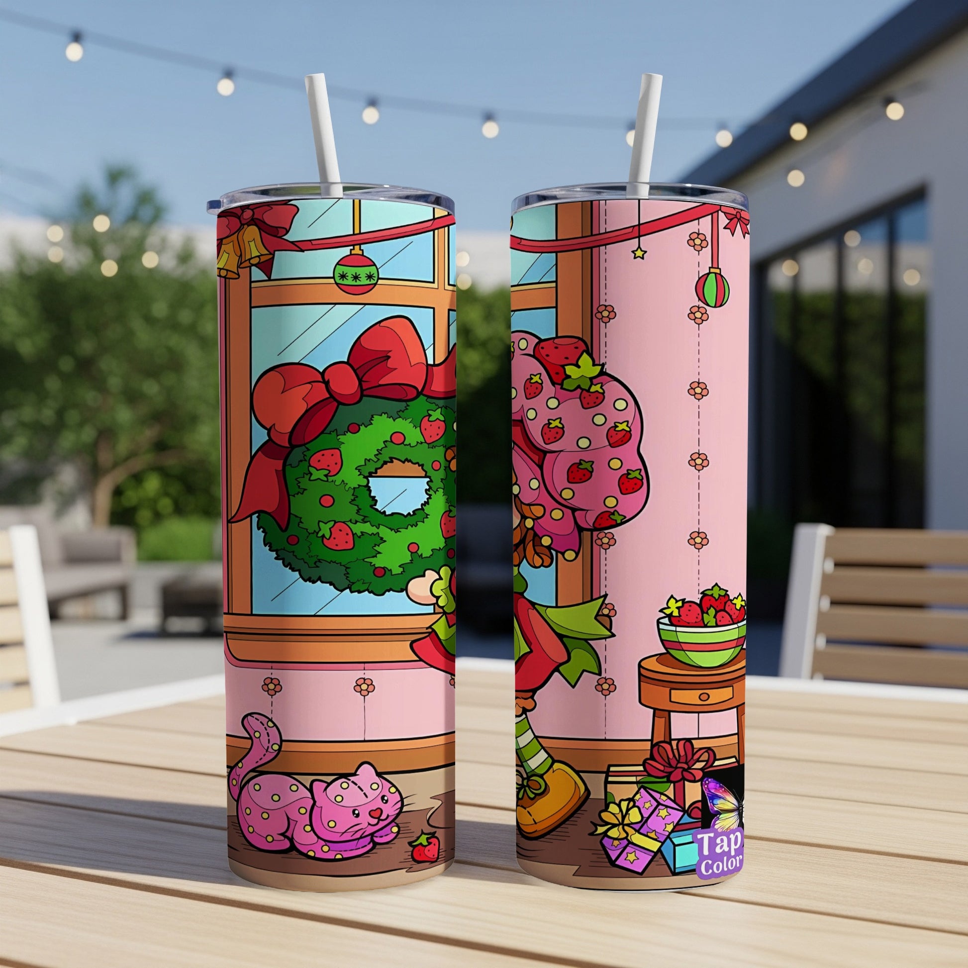 Two pink tumblers with Strawberry Shortcake and festive holiday designs.