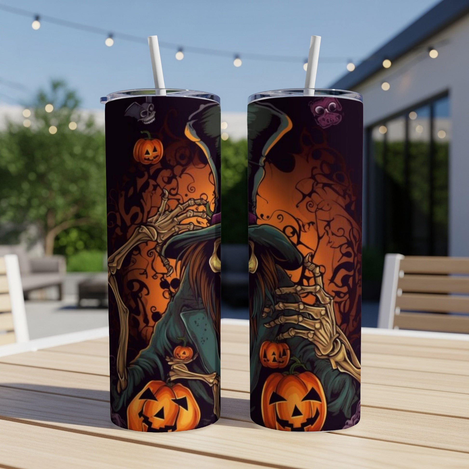 Halloween witch and pumpkin design on two tumblers with straws.