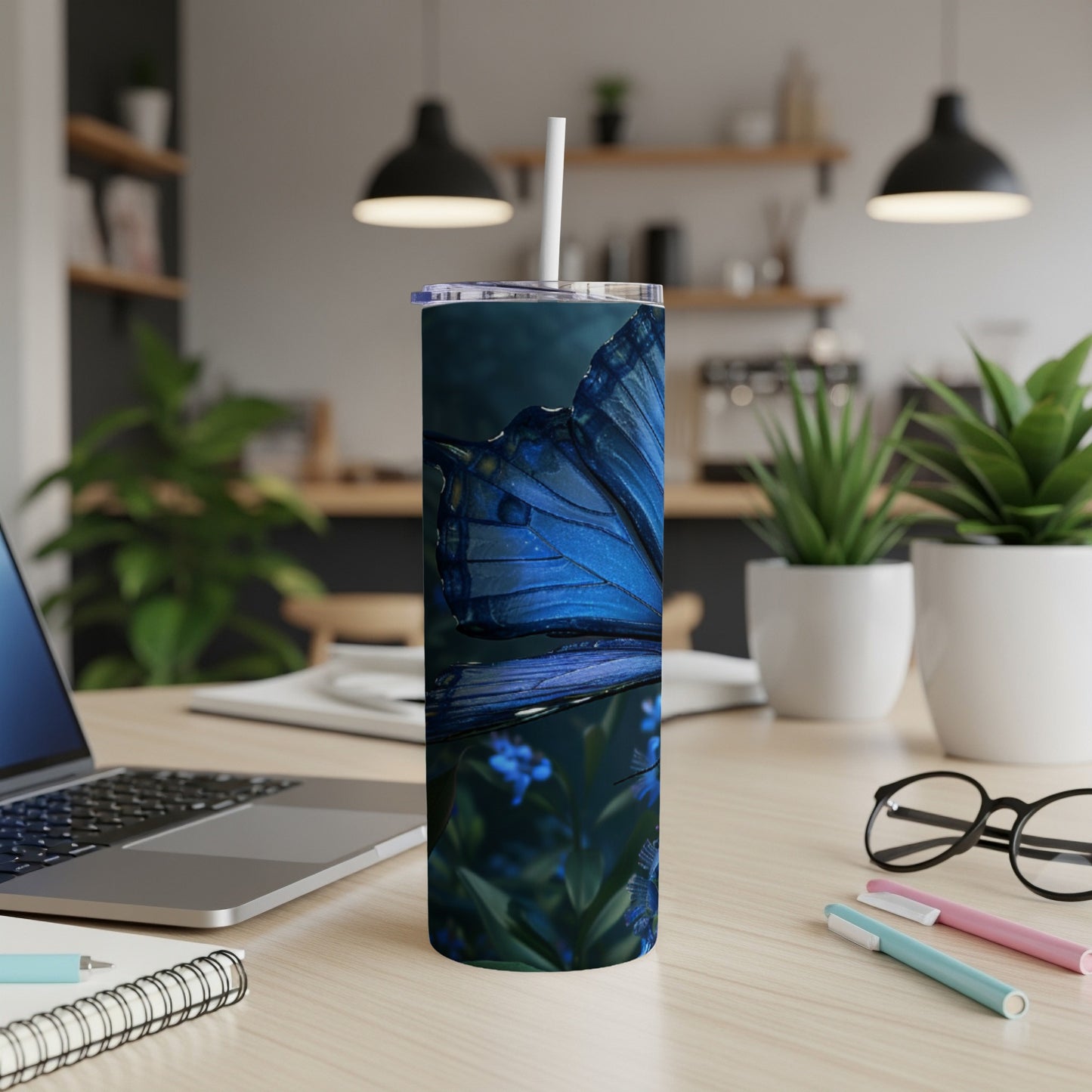 Blue butterfly on a dark background, shown on a tumbler with a straw.