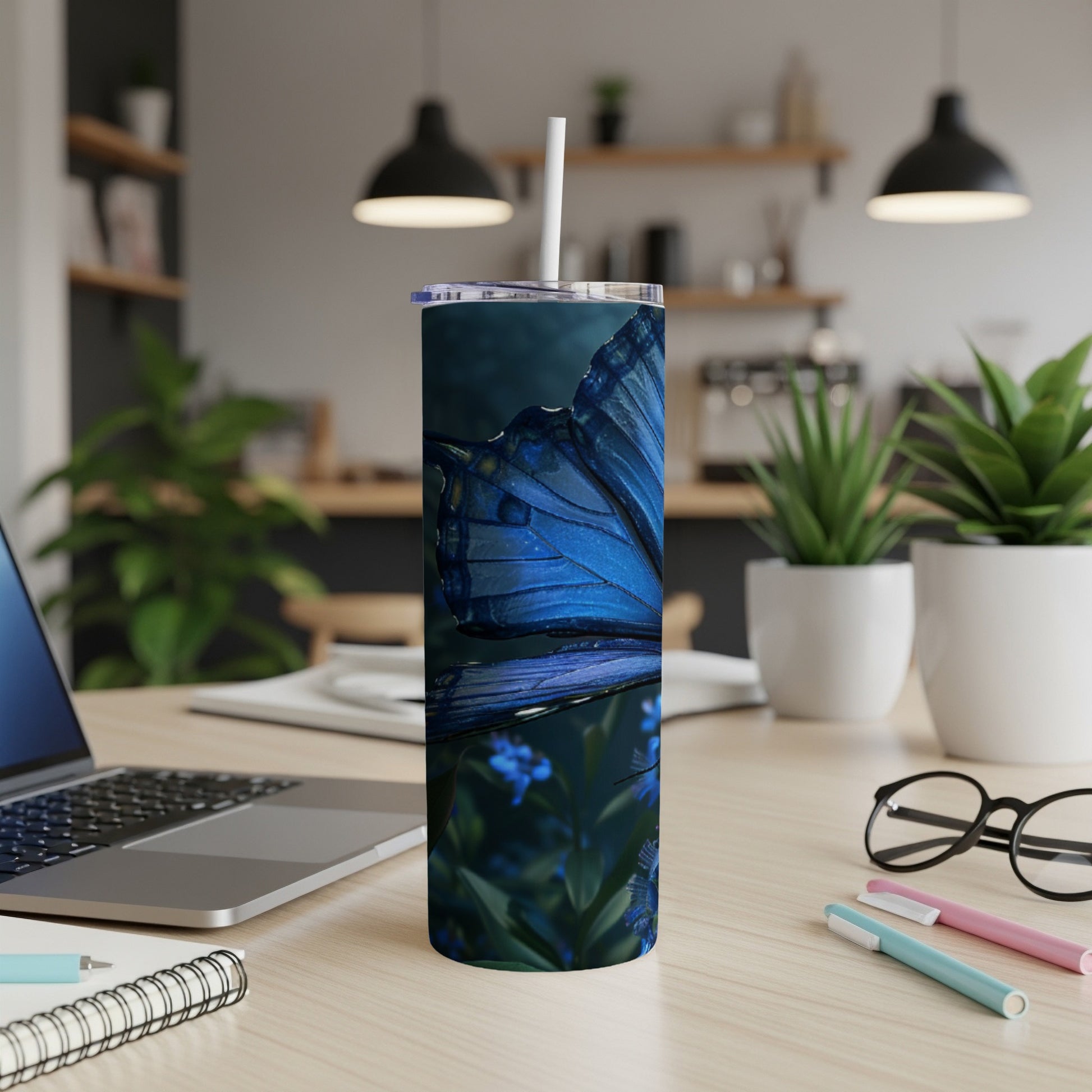 Blue butterfly on a dark background, shown on a tumbler with a straw.