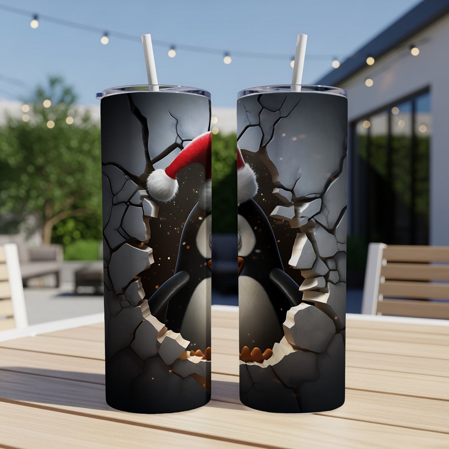 Two tumblers featuring a festive penguin breaking through cracked walls.