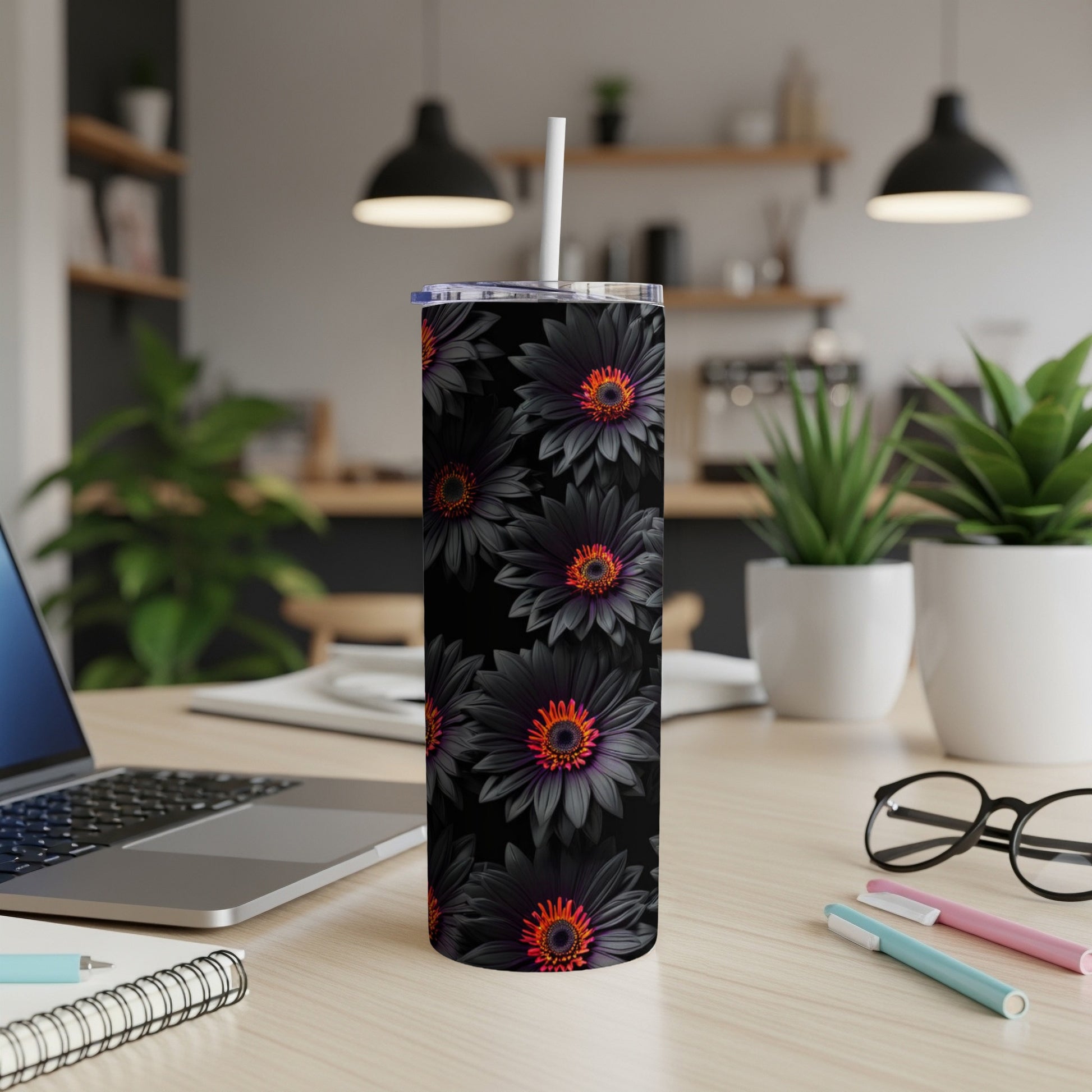 Black tumbler with dark floral pattern and white straw.