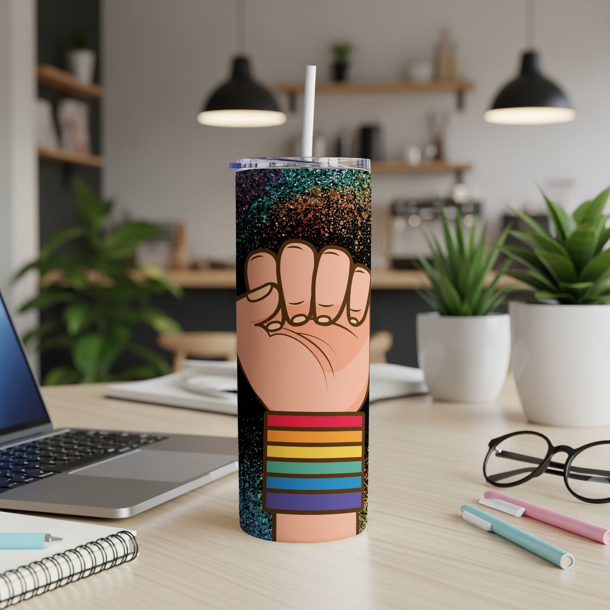 Pride tumbler with raised fist design and rainbow stripes.