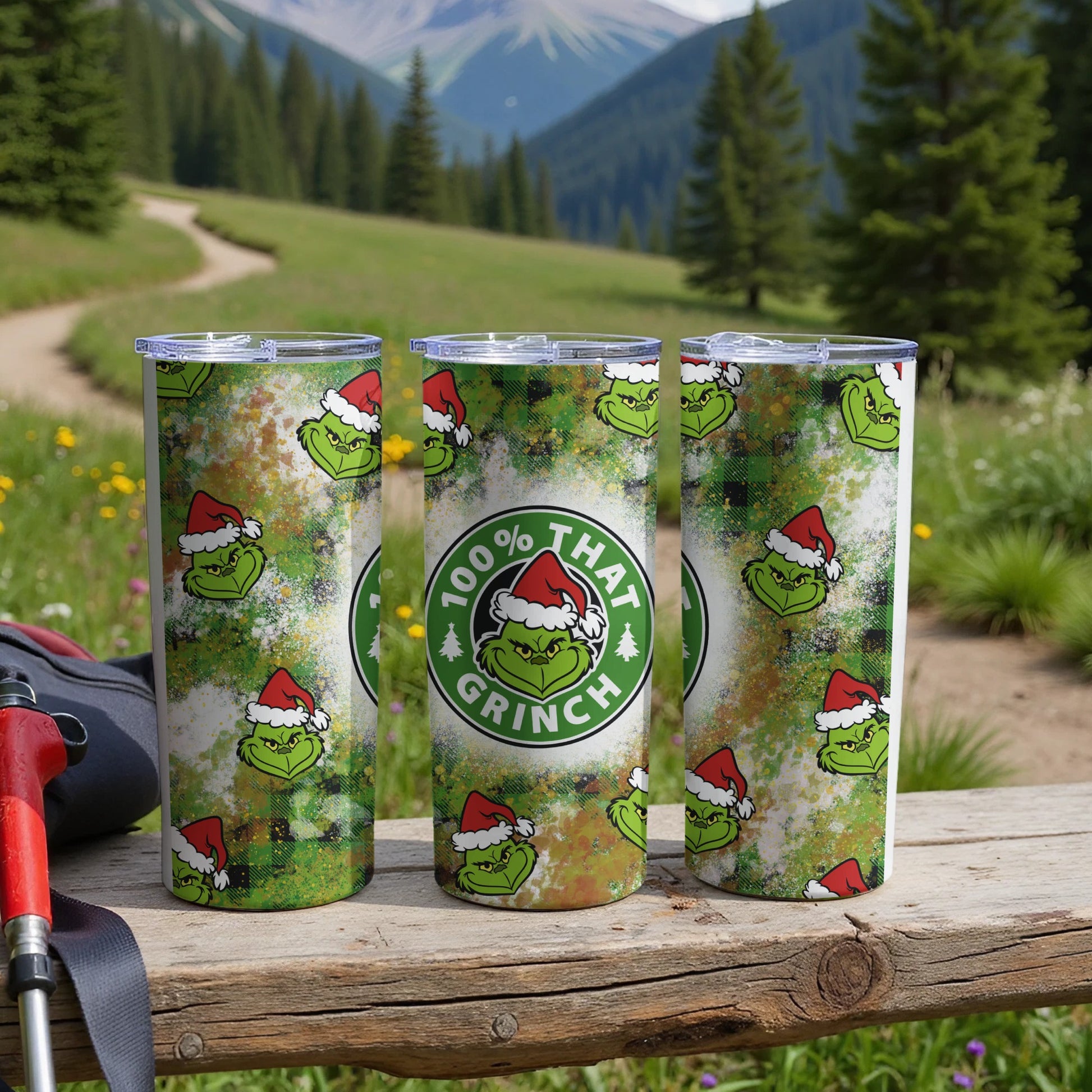 Three tumblers with a Grinch pattern and "100% That Grinch" text.