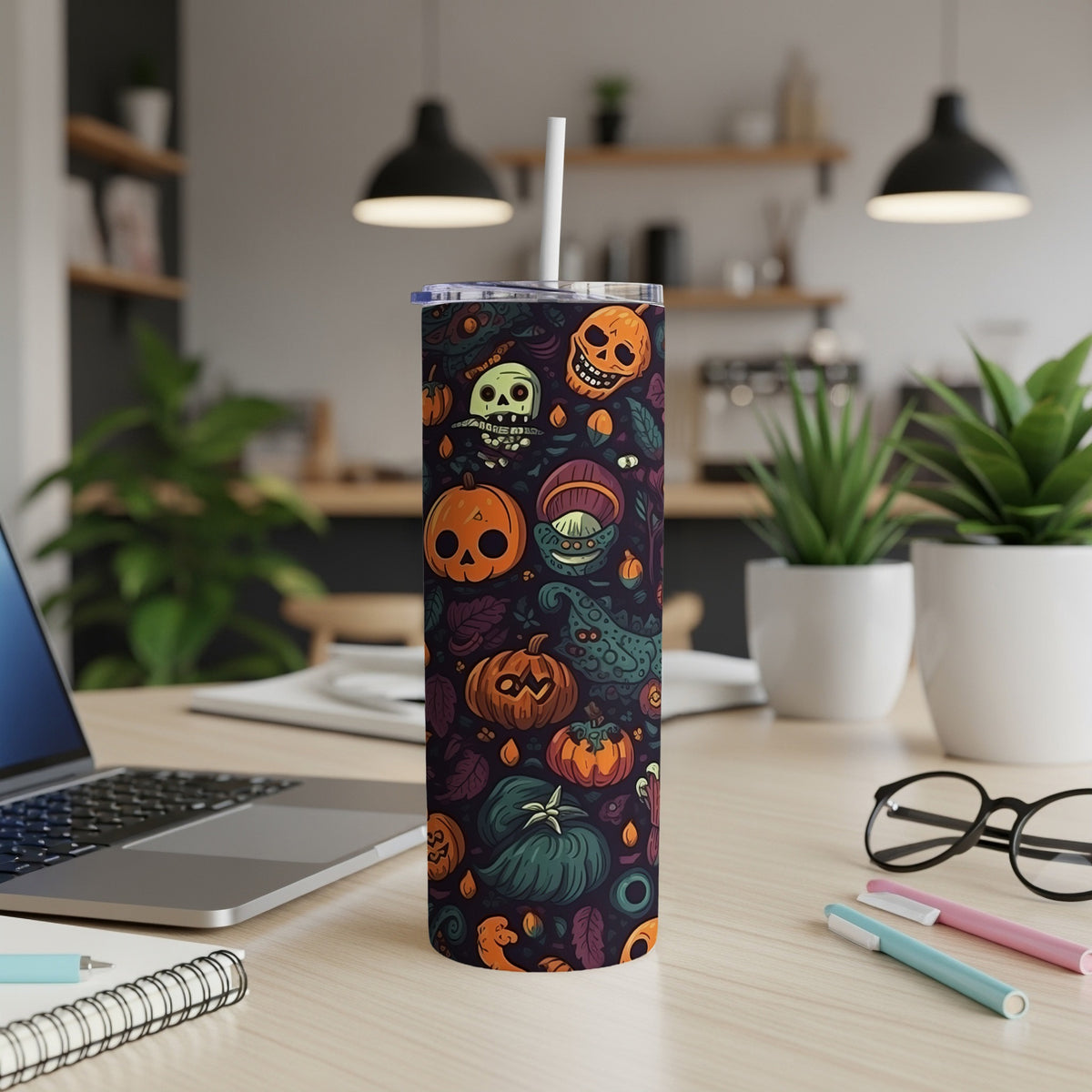 Tall tumbler with Halloween pattern featuring pumpkins, skulls, and spooky elements.