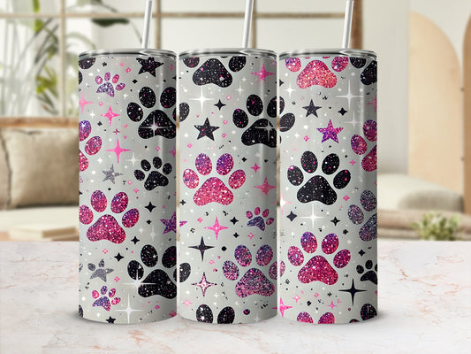 Glittery paw prints and stars adorn three tumblers on a marble countertop.
