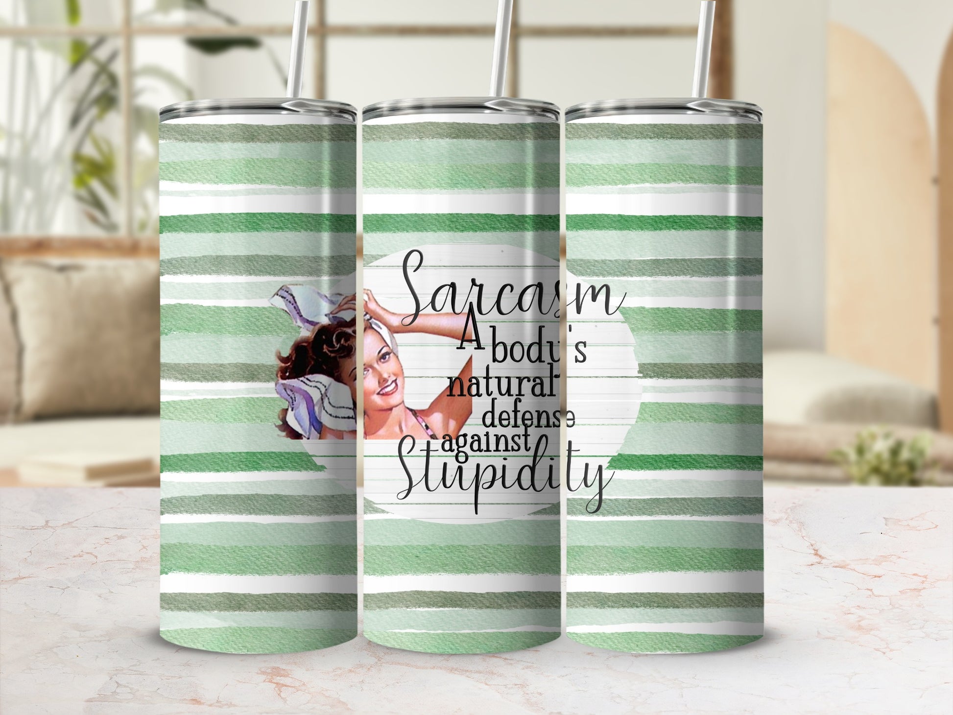 Green striped tumbler with woman and "Sarcasm a body's natural defense against stupidity" quote.
