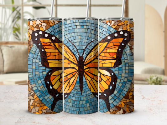 Tumbler with orange and black mosaic butterfly design on a blue background.