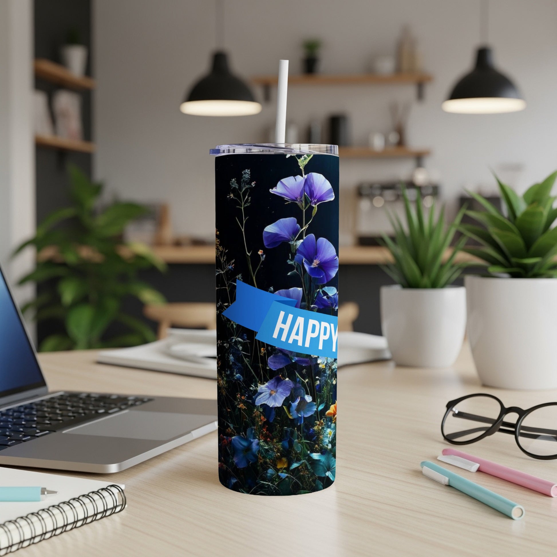 Tall tumbler with blue flowers and "HAPPY" text on a blue ribbon.