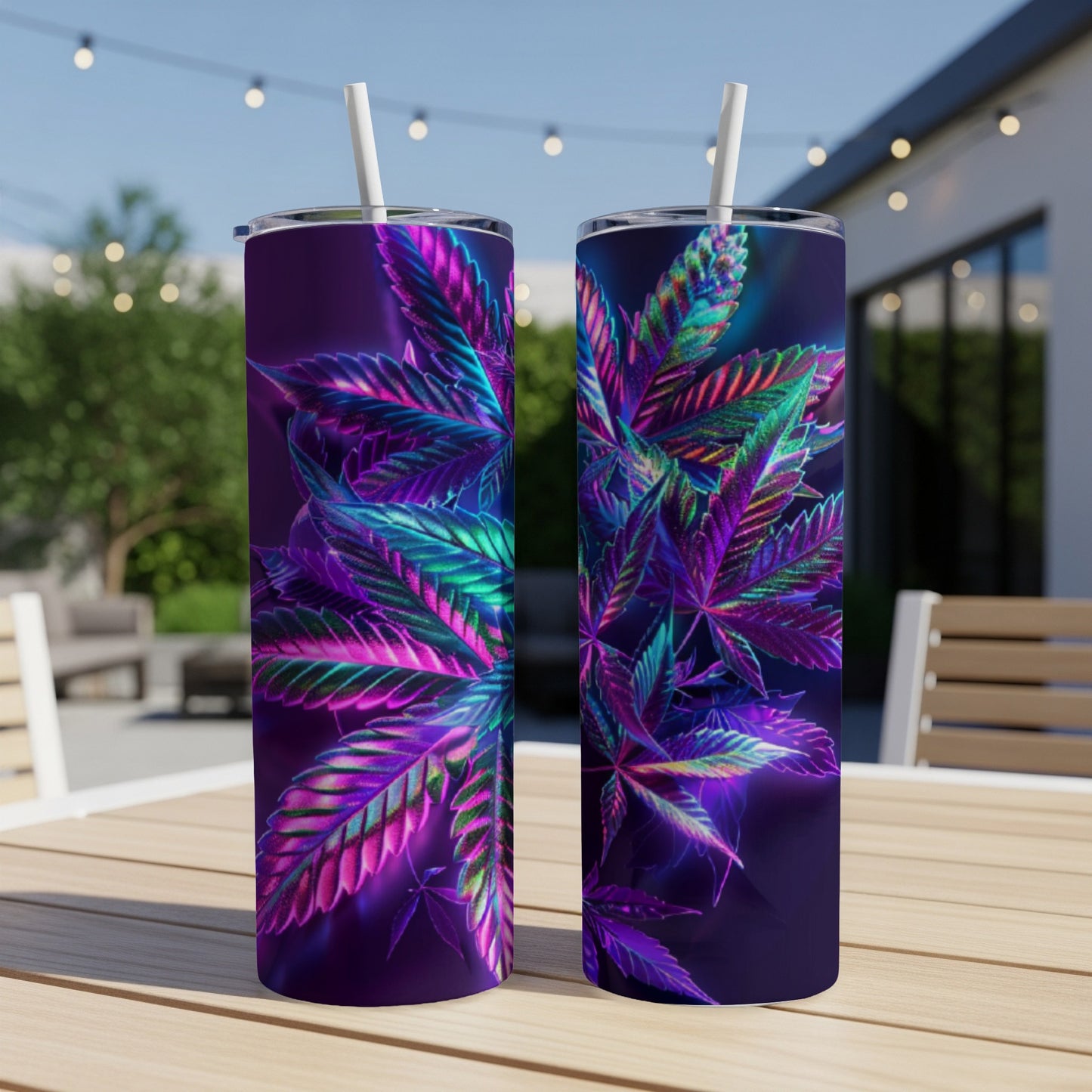 Two tall tumblers with colorful cannabis leaf designs on a table.