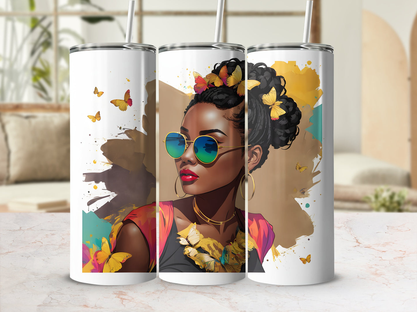 Three tumblers featuring a woman with butterflies and colorful abstract art.