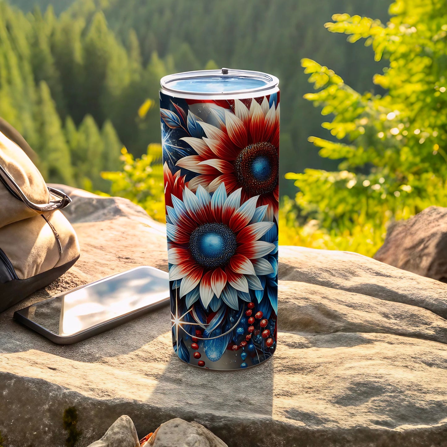 Tall tumbler with red and blue sunflower and berry design on outdoor rock.