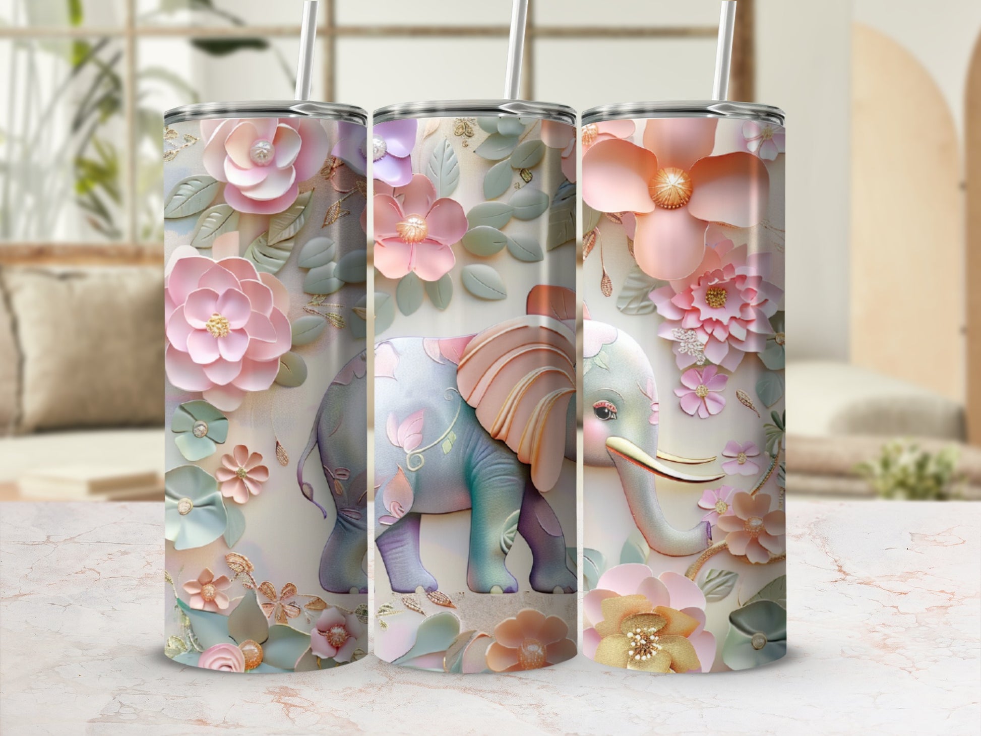 Three tumblers with floral elephant designs and pastel colors.