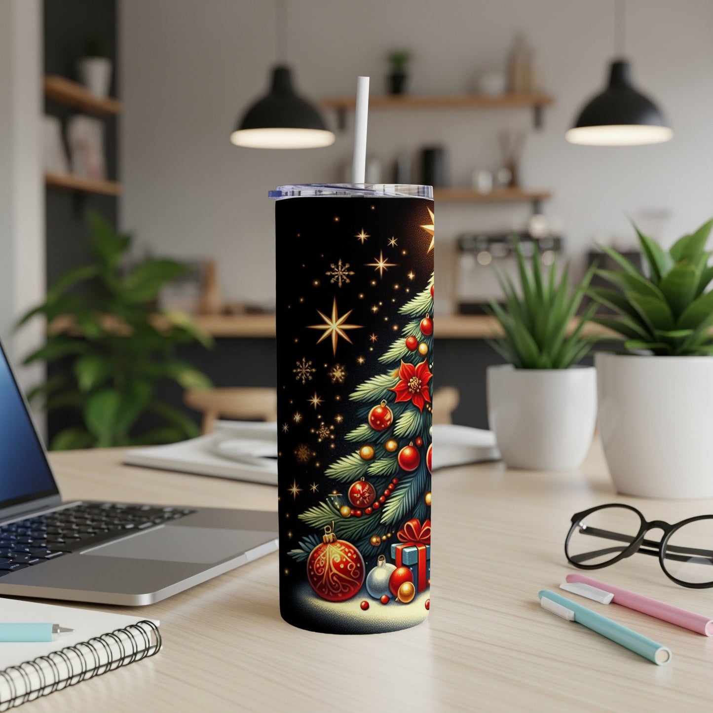 Christmas tree with ornaments and gifts on a black tumbler.
