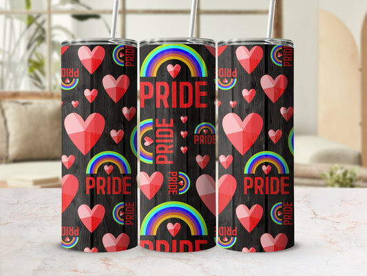Three tumblers with rainbow and heart pride design on black wood background.