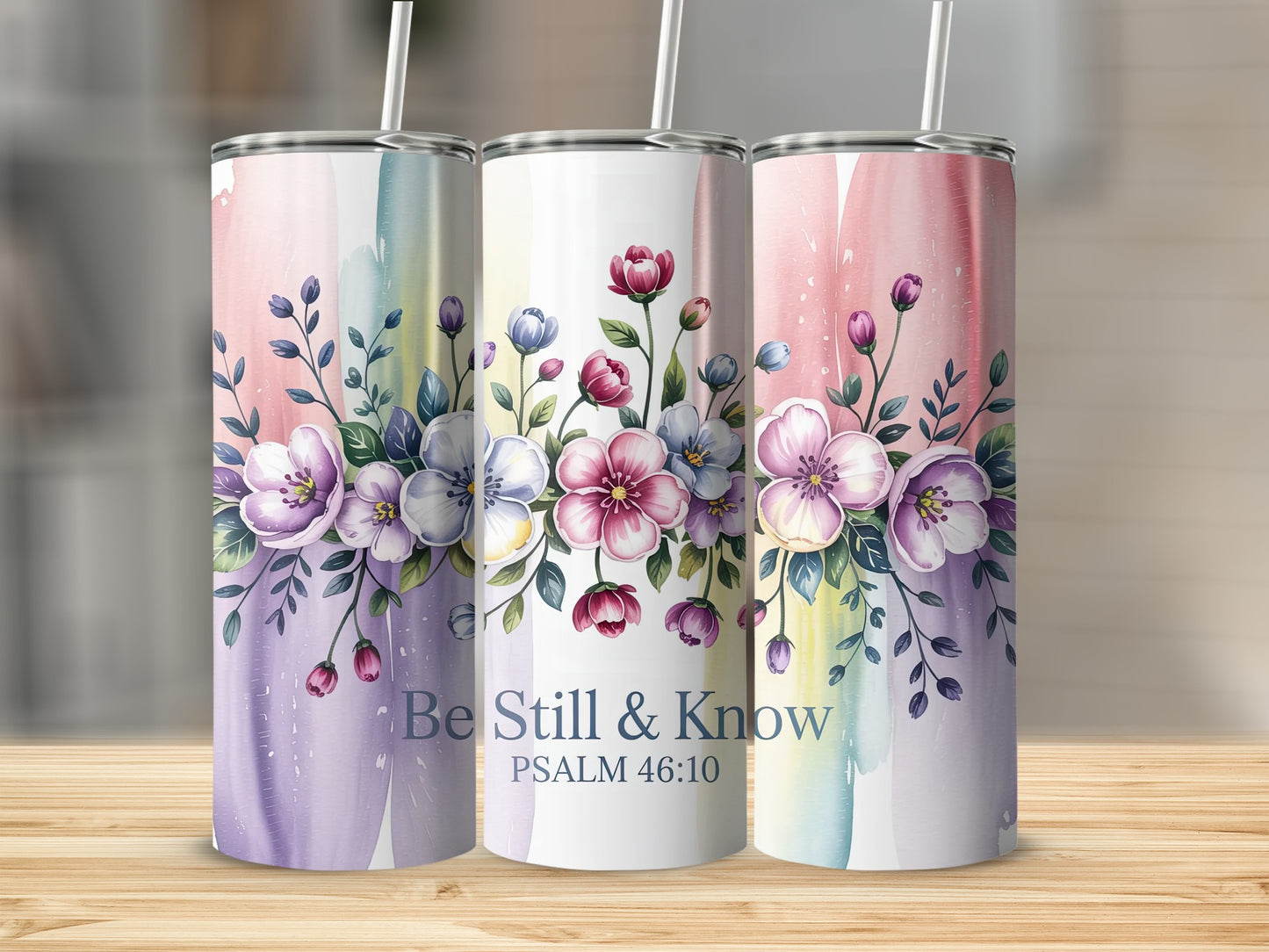 Three tumblers with floral watercolor designs and "Be Still & Know" text.