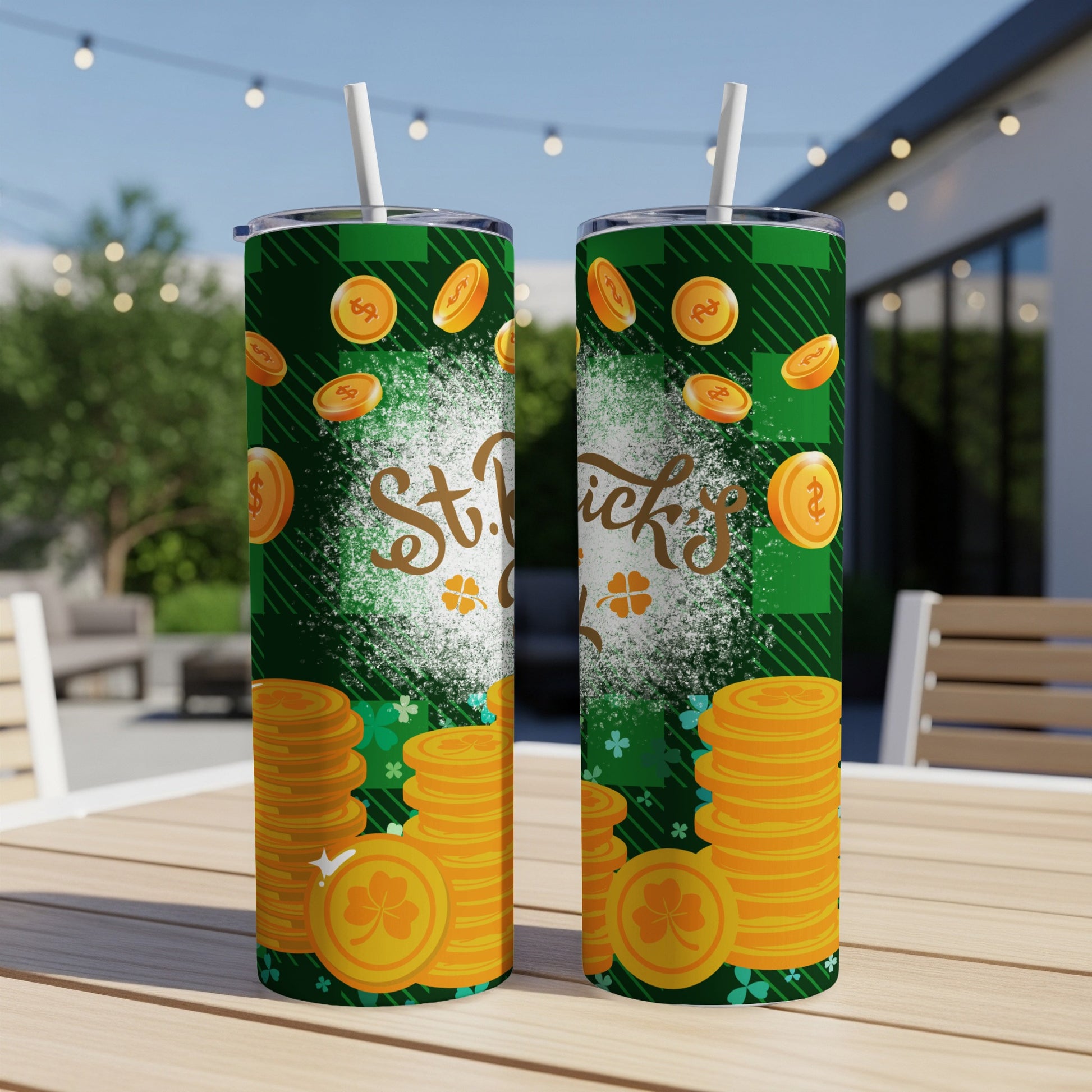 Two St. Patrick's Day tumblers with coins and shamrocks on a table.