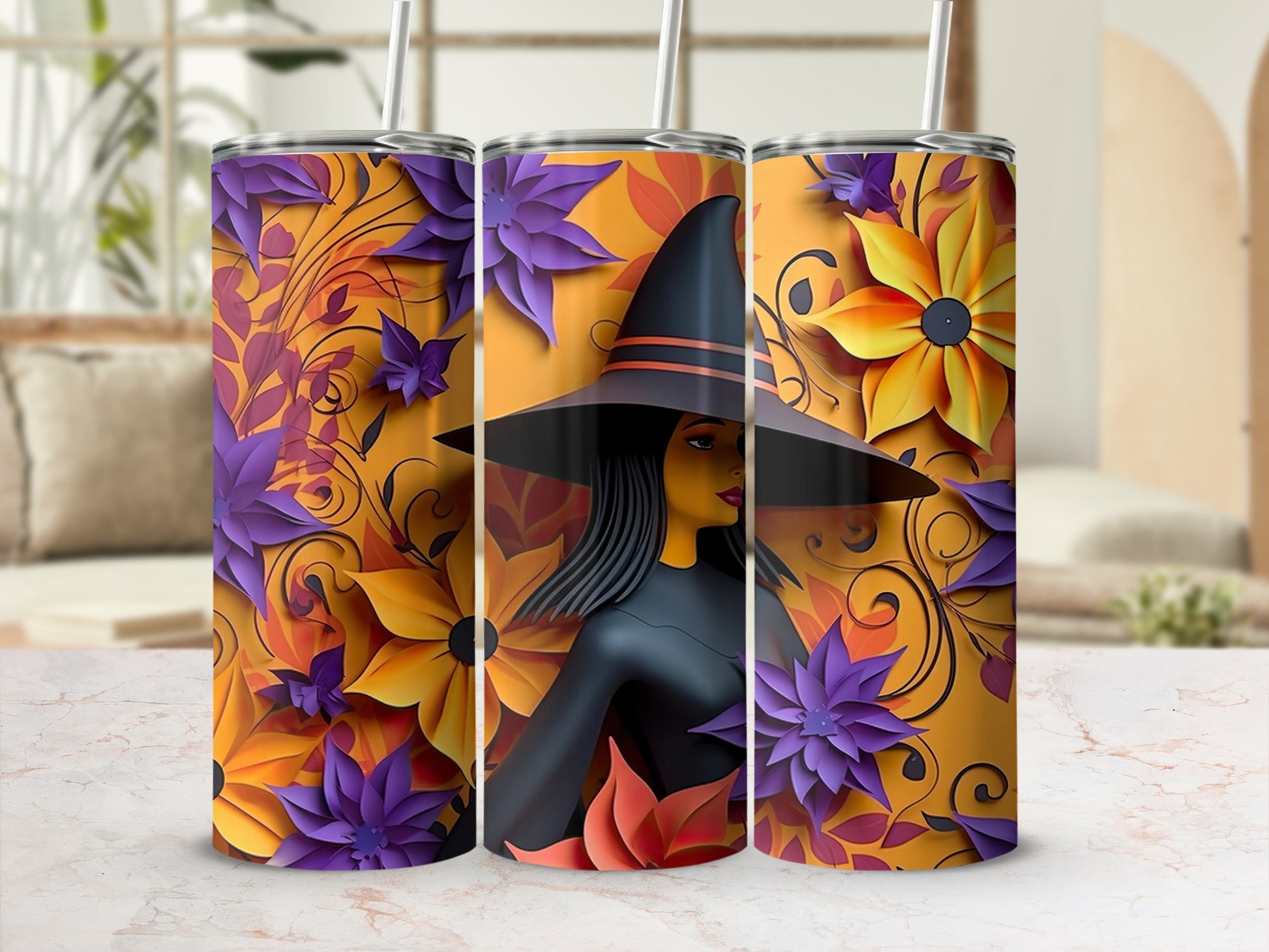 Three tumblers with a witch and floral design in orange, purple, and yellow.