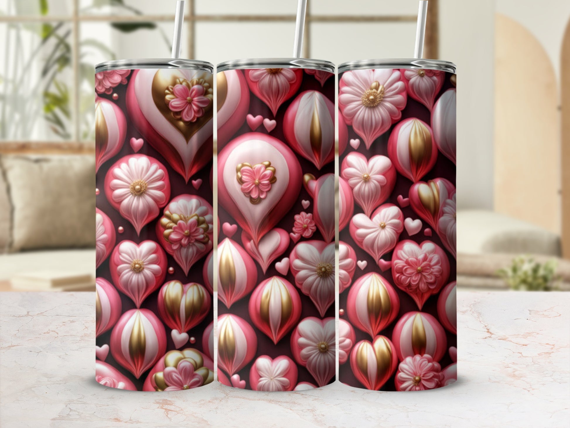 Three tumblers with a pink and gold floral and heart design.