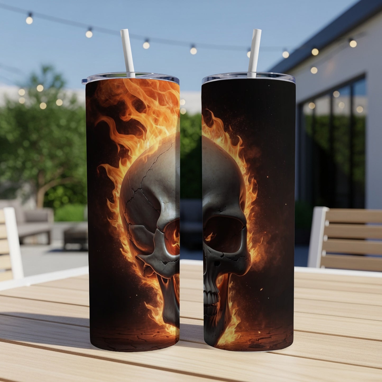 Two tumblers with a flaming skull design sit on a table.