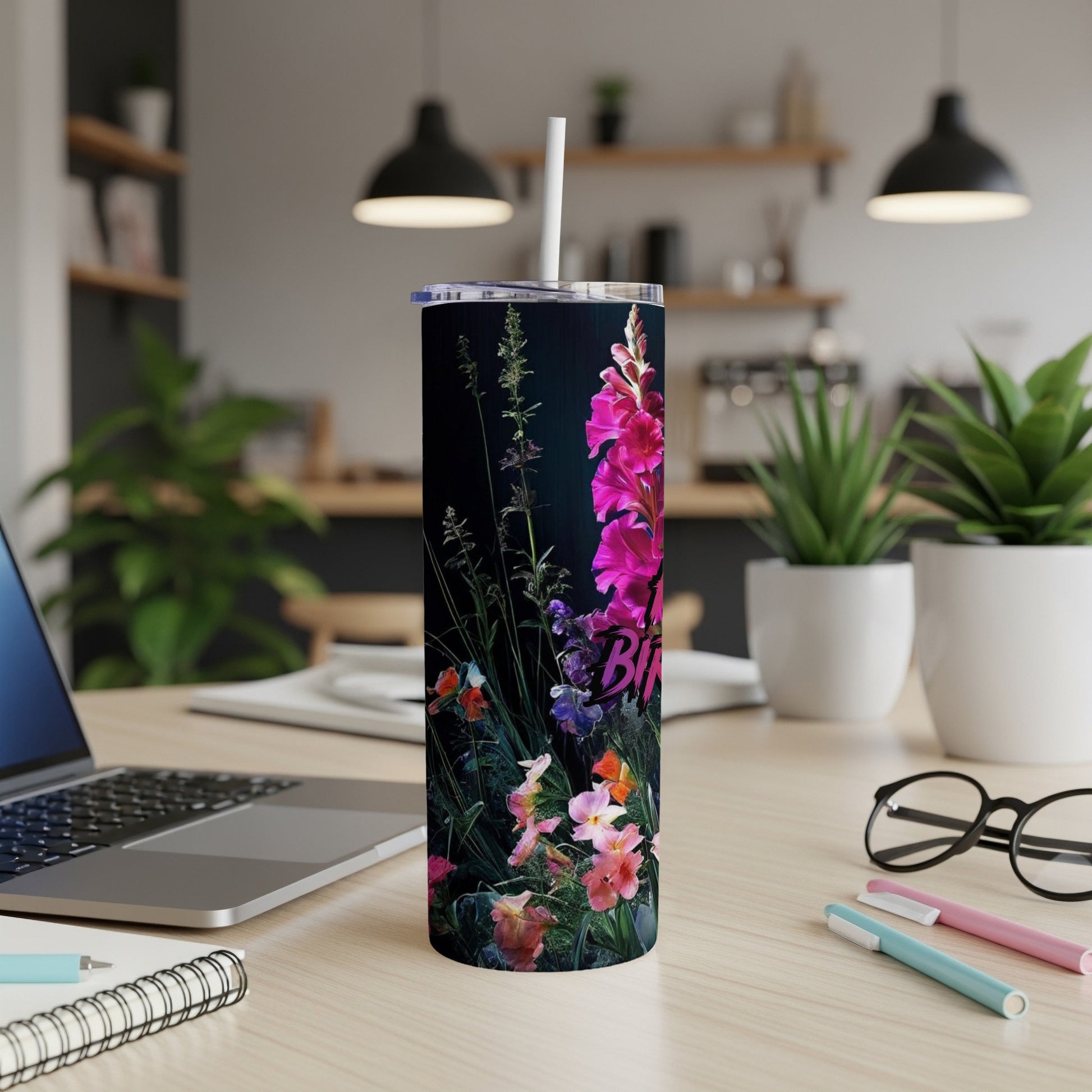 Tall floral tumbler with pink, purple, and orange flowers on a dark background.