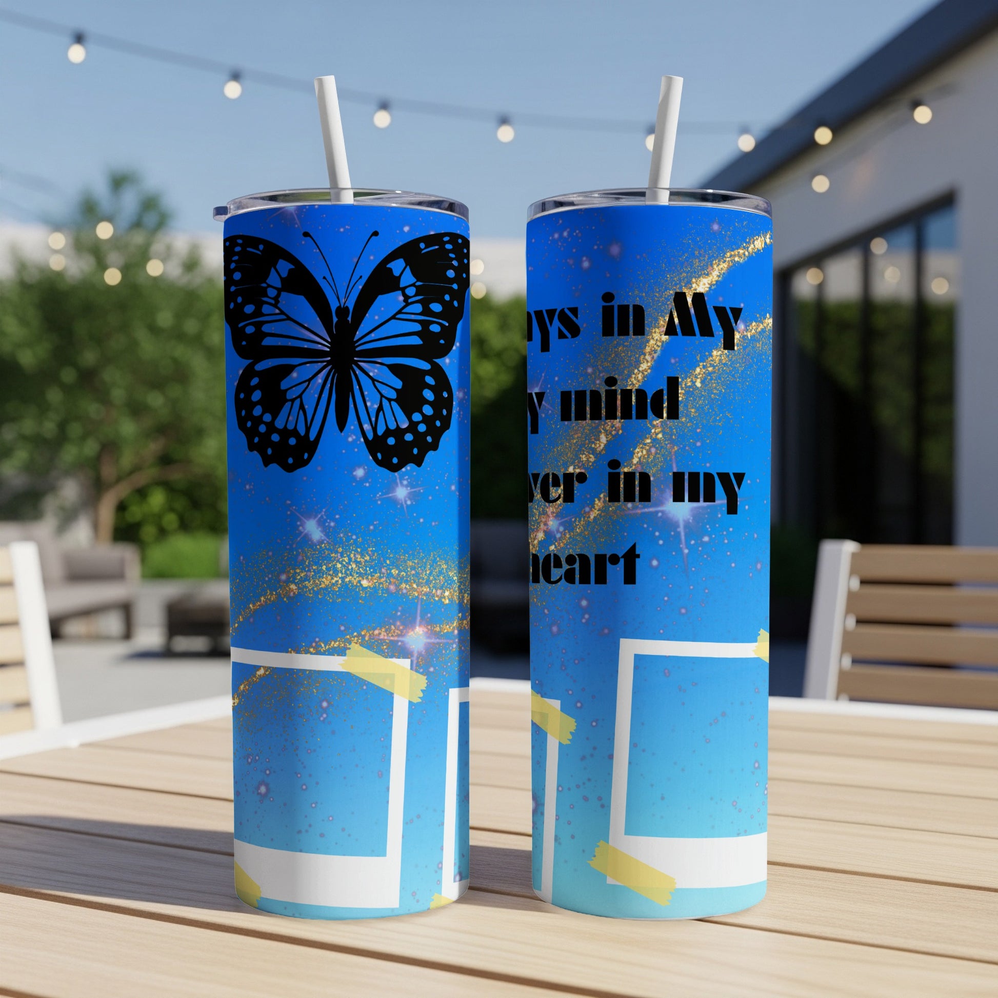 Two tumblers with blue ombre design, black butterfly, gold glitter, and text that says "always in my mind, forever in my heart".