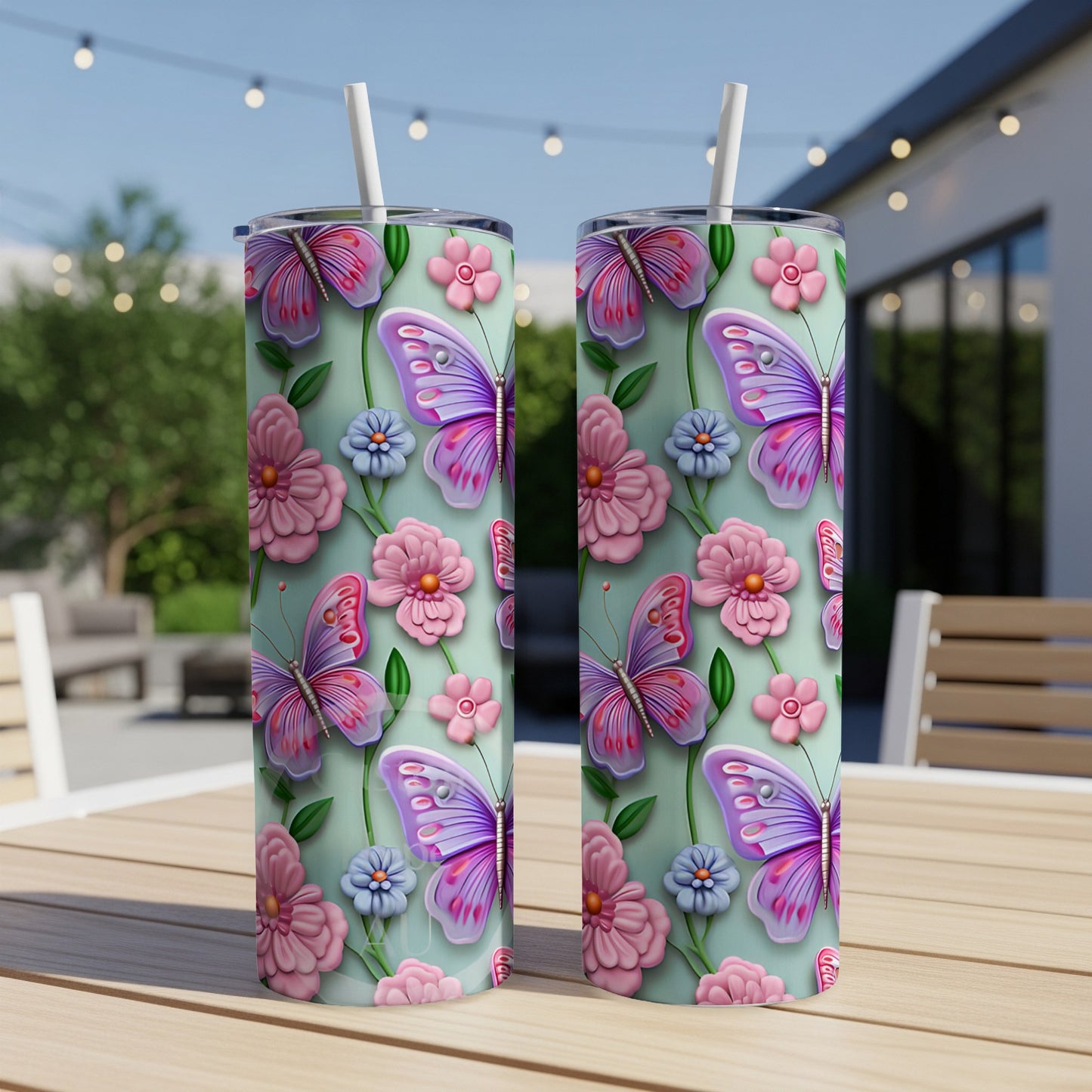 Two tall tumblers with a pastel floral and butterfly design.
