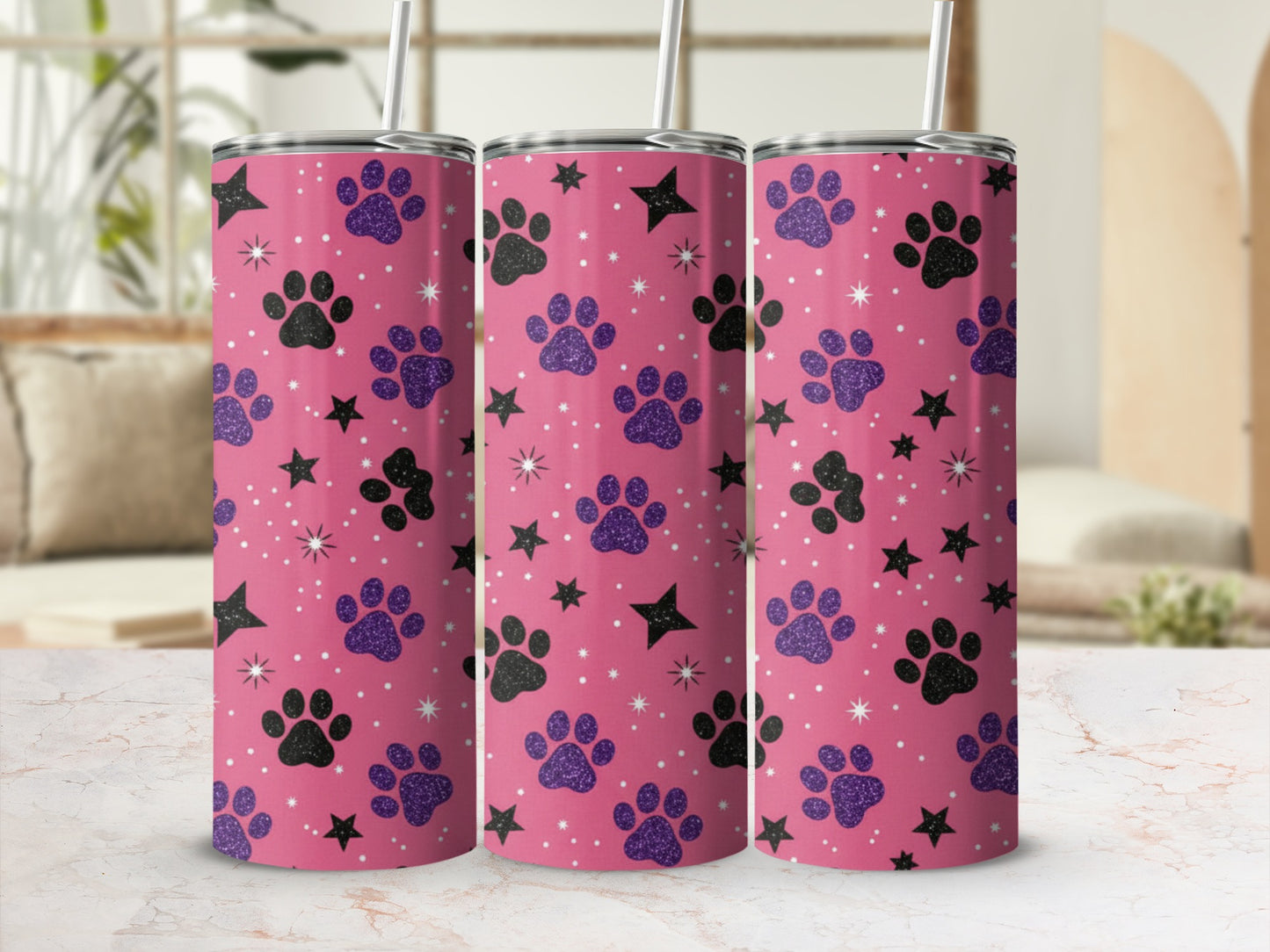 Pink tumbler with black and purple paw prints and stars.